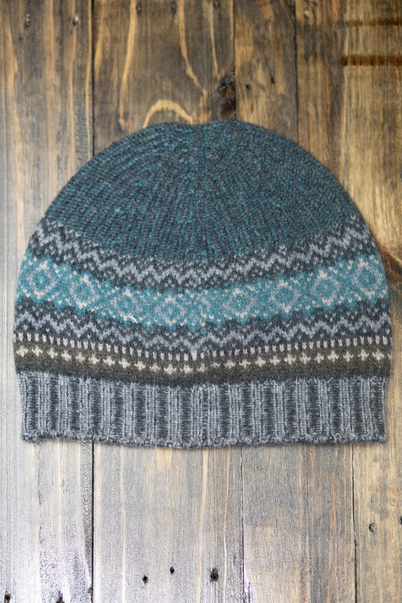 Northern Isles Merino Wool Beanie in Gray on a wood background - L'Atelier Global