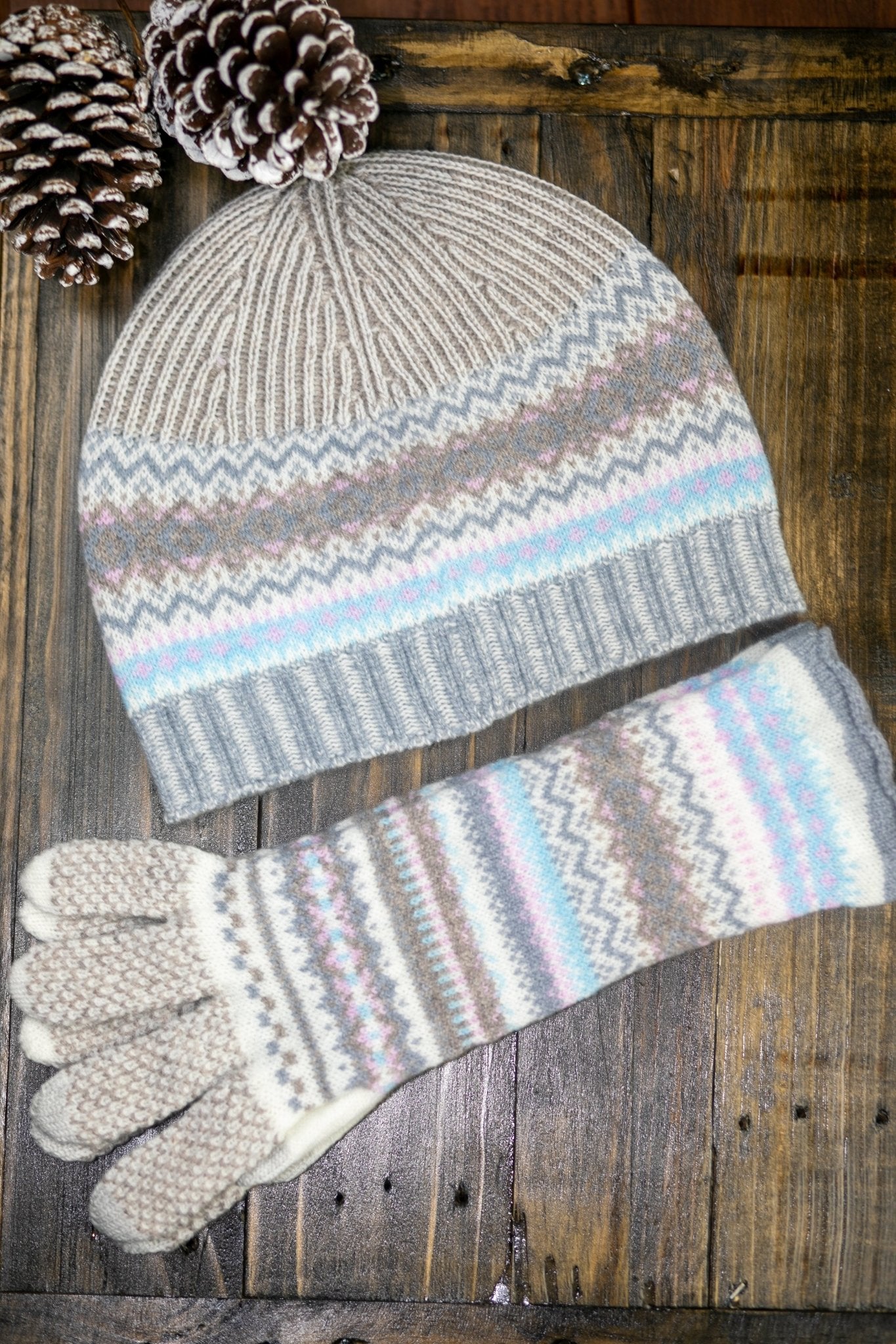 Northern Isles Merino Wool Beanie and Gloves in Mist on a wood background with snowy pinecone in top left - L'Atelier Global