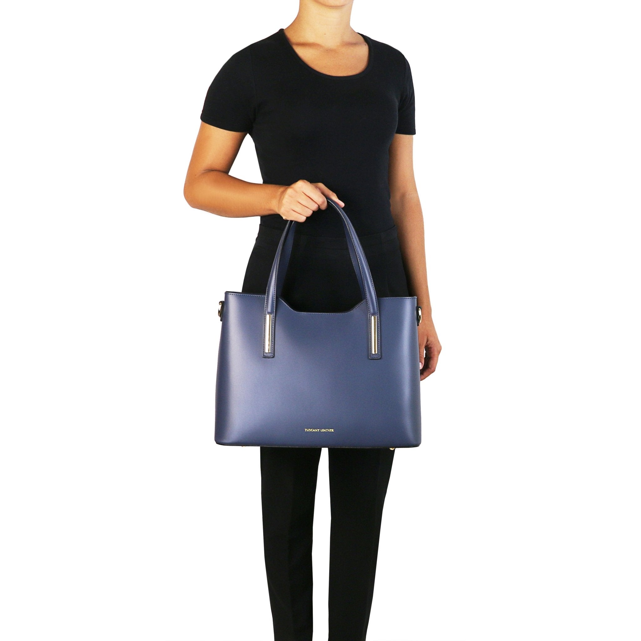 Olimpia Leather Tote in dark blue held by model wearing black top and pant to show scale and size - L'Atelier Global