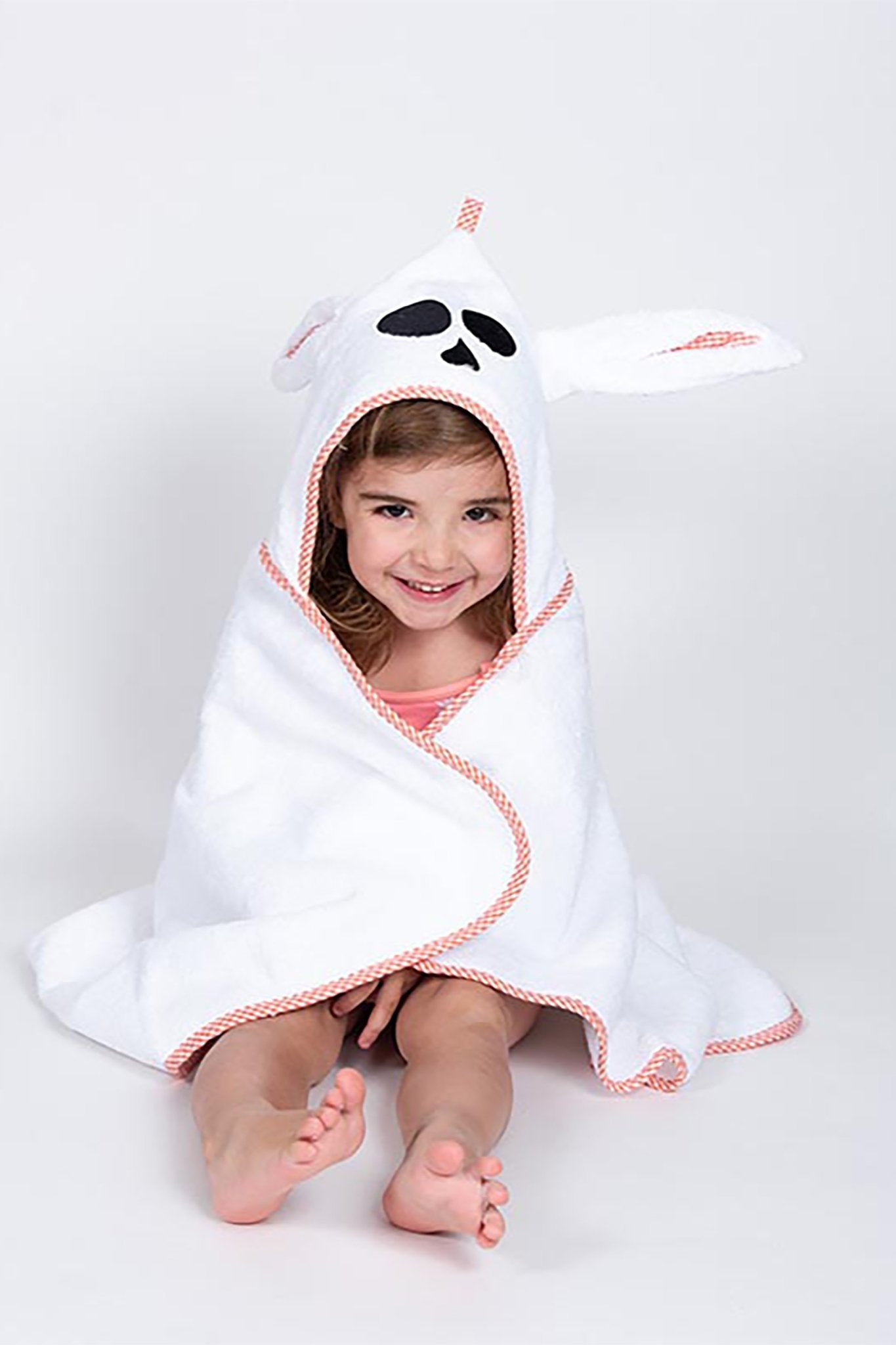 A young boy wearing the unisex French Organic Cotton Bath Cape - L'Atelier Global