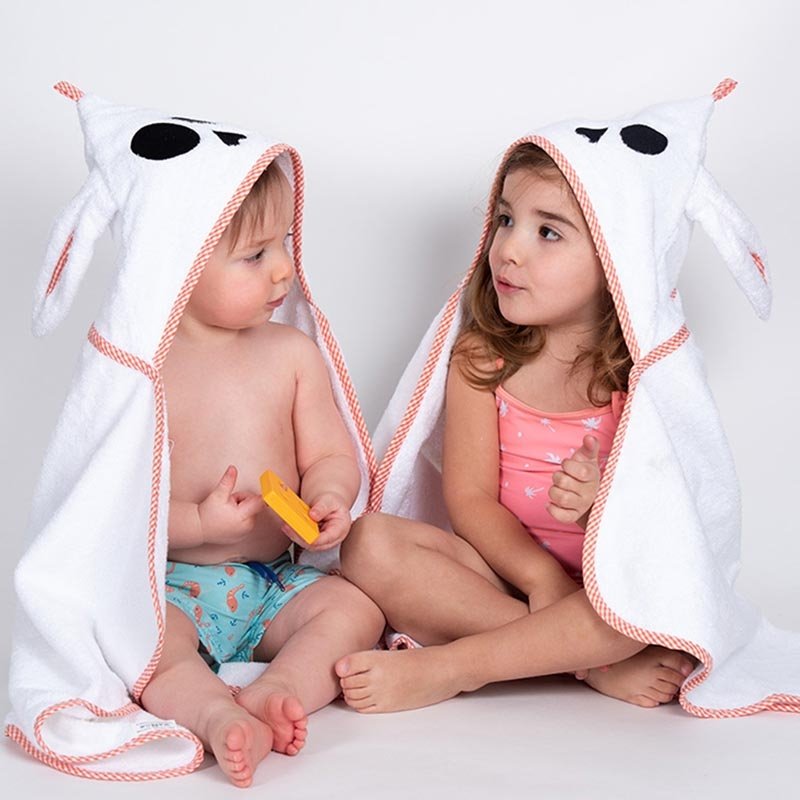 A young boy and girl wearing the unisex French Organic Cotton Bath Cape - L'Atelier Global