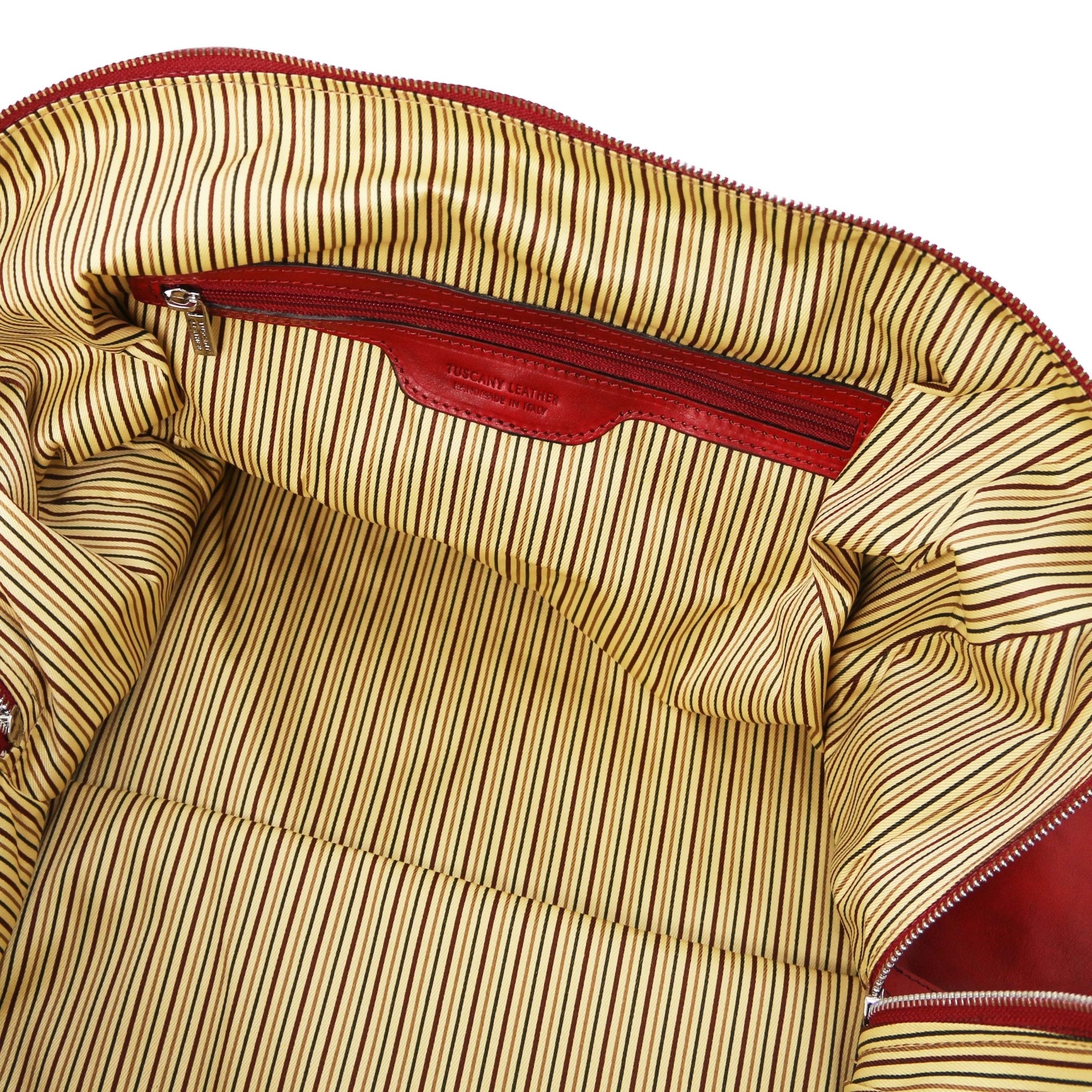 Interior zip pocket view Oslo Travel Leather Weekender Duffle Bag in red showing vintage striped cotton ticking lining