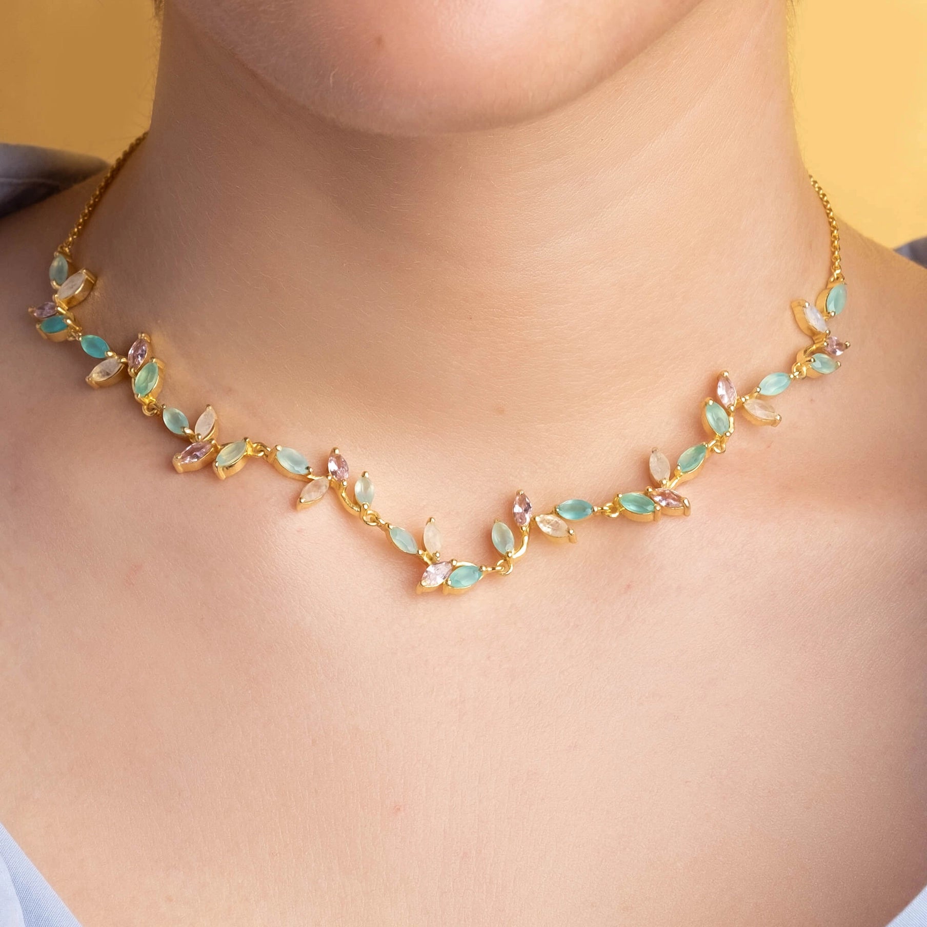 A close up neck view of a female model wearing the Padma Lotus Flower Spanish Choker Necklace - L'Atelier Global