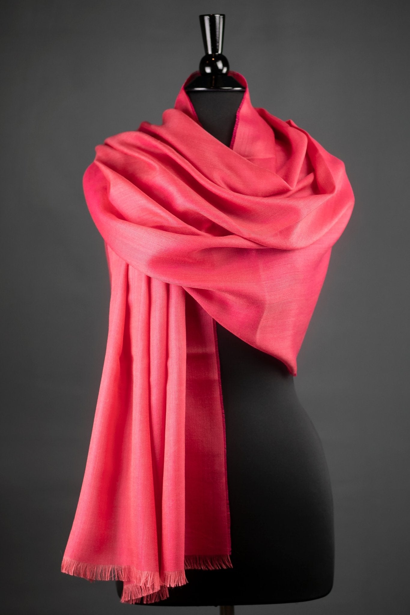 Peruvian Baby Alpaca and Silk Stole in Dark Coral wrapped on a black bust form with a dark gray background