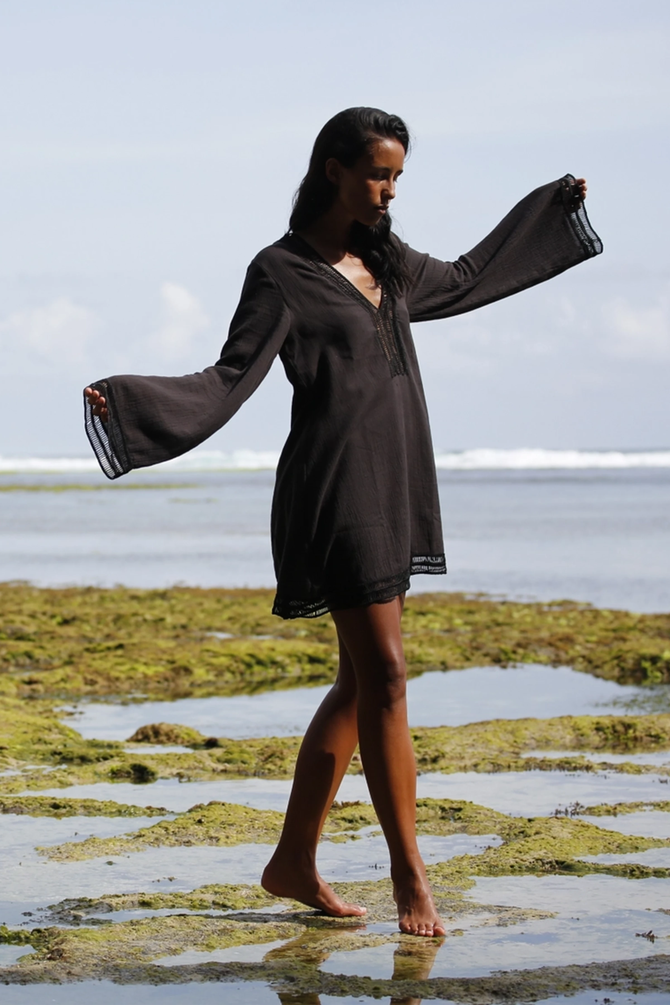 Model playing on beach wearing the Positano Turkish Cotton Cover Up Dress in Black