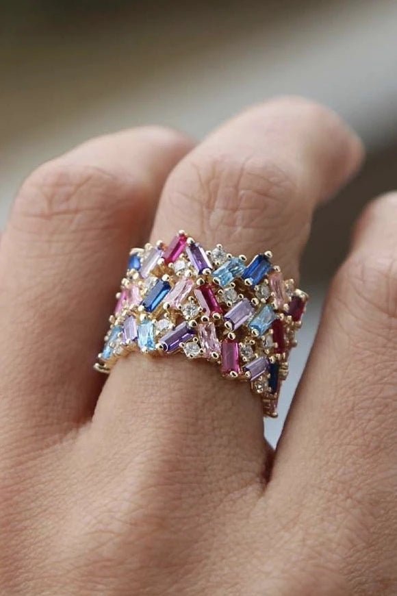 Rainbow Baguette Gold Ring on a model's middle finger