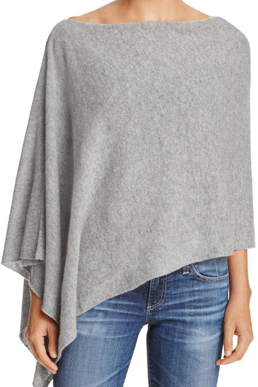 A model wearing the Ravello Cashmere Poncho in gray on blue jeans