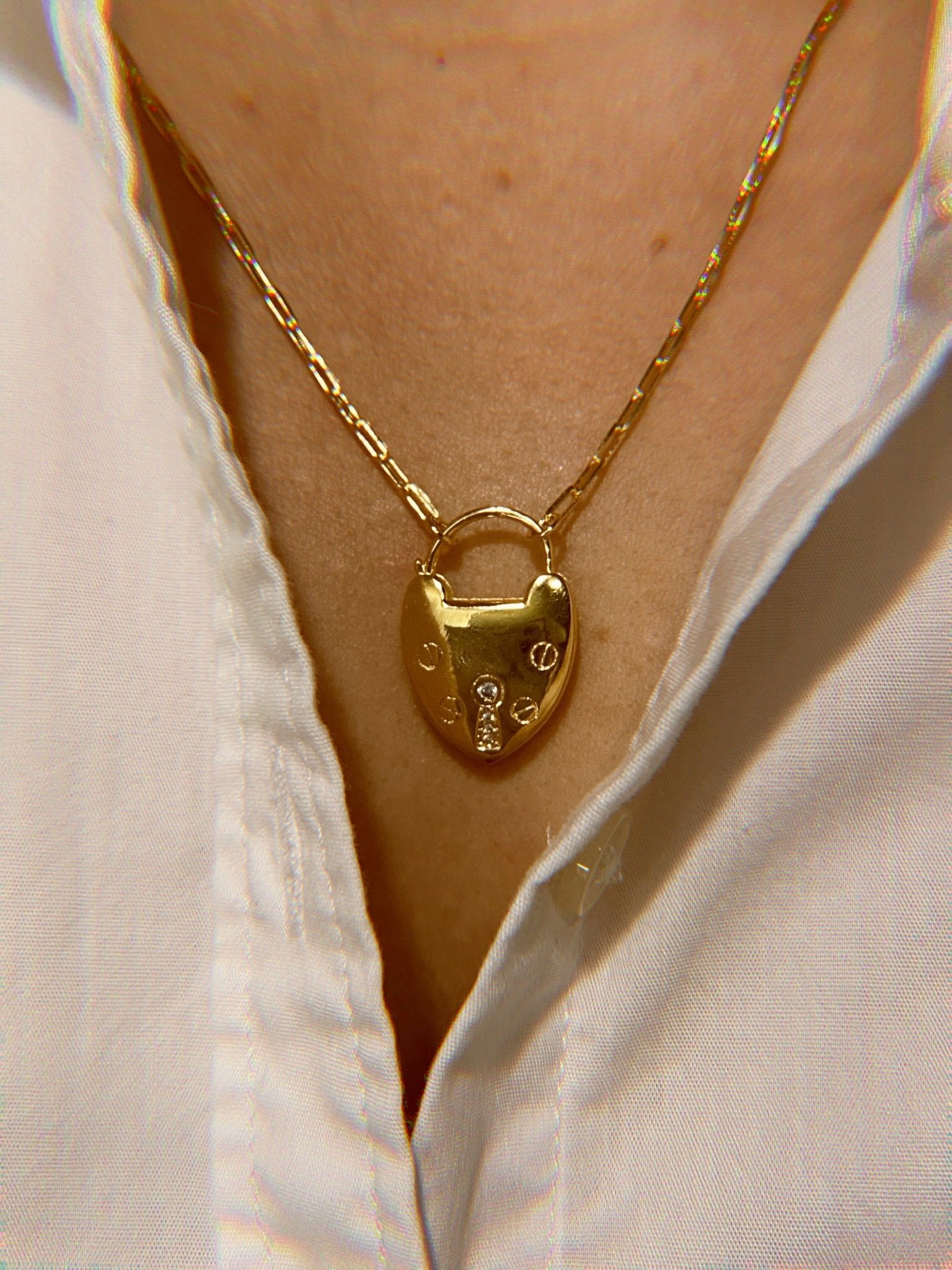 Rio Gold Lock Heart Necklace on model - close up image of front of necklace with nailhead design and keyhole