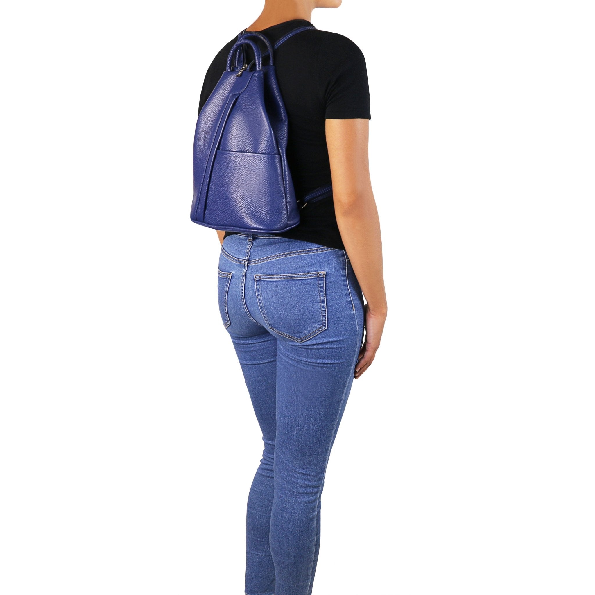 Shanghai Leather Backpack in blue on female model wearing blue jeans and a black short-sleeved shirt untucked