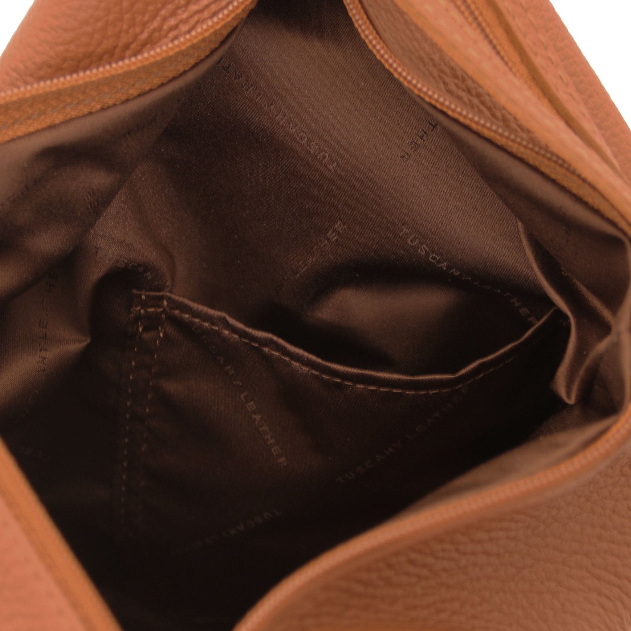 Interior open pocket view Shanghai Leather Backpack in cognac showing brown lining