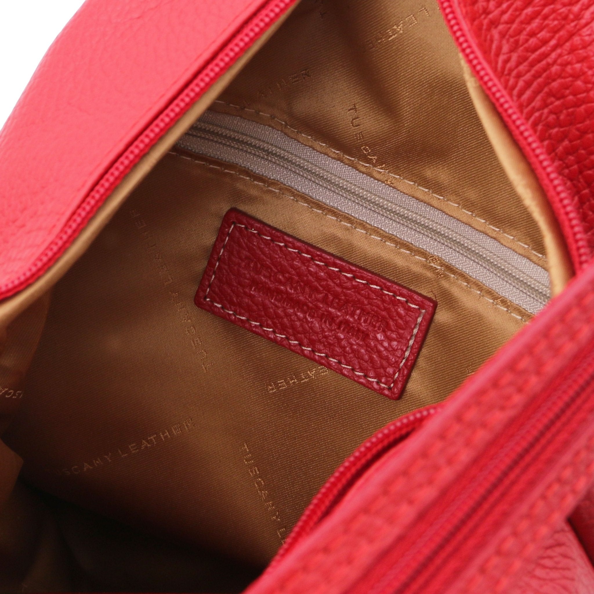 Interior zip pocket view Shanghai Leather Backpack in red showing gold lining