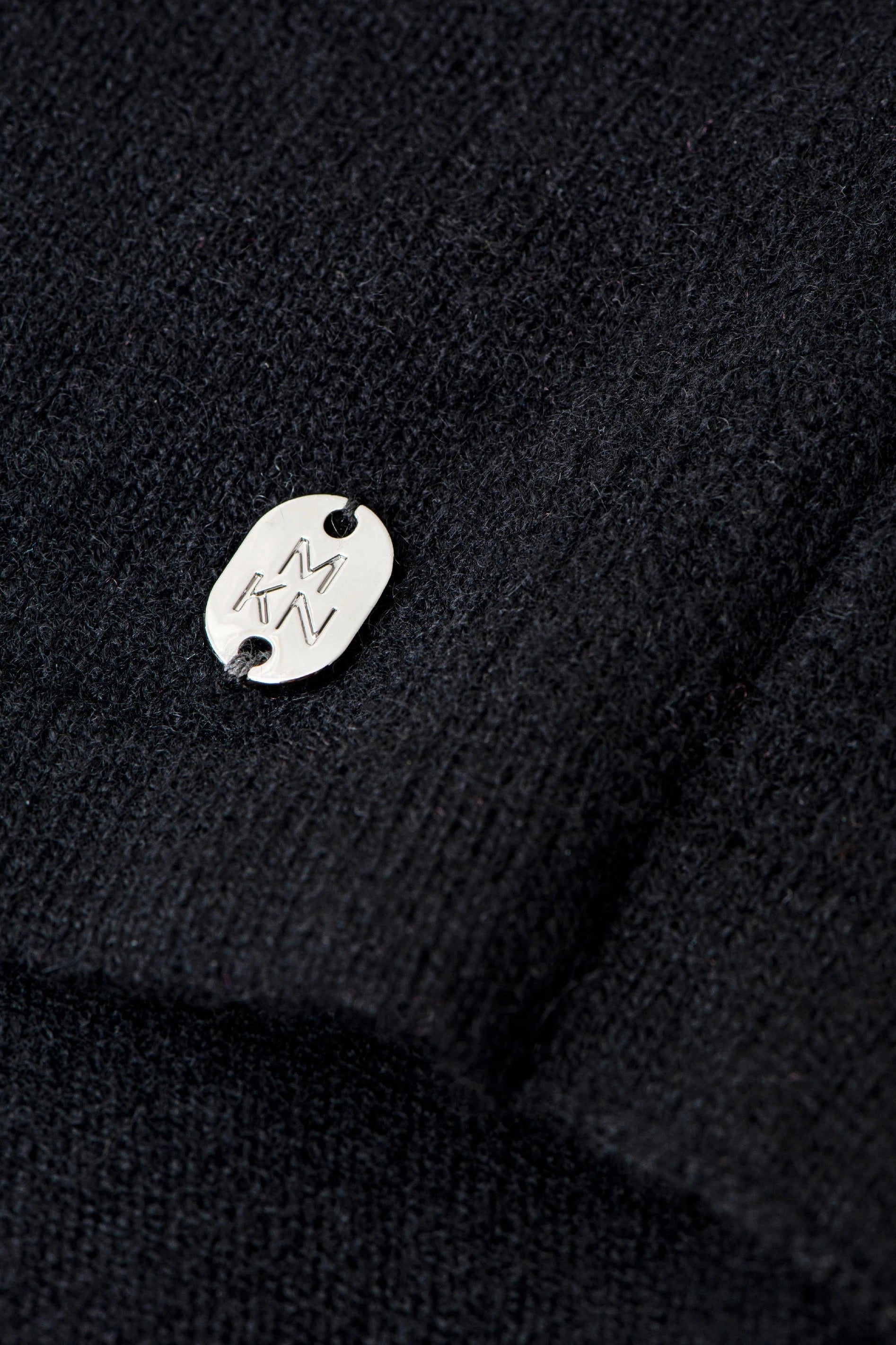Close up fabric view of the Siena Soft Cashmere Poncho in black - L'Atelier Global