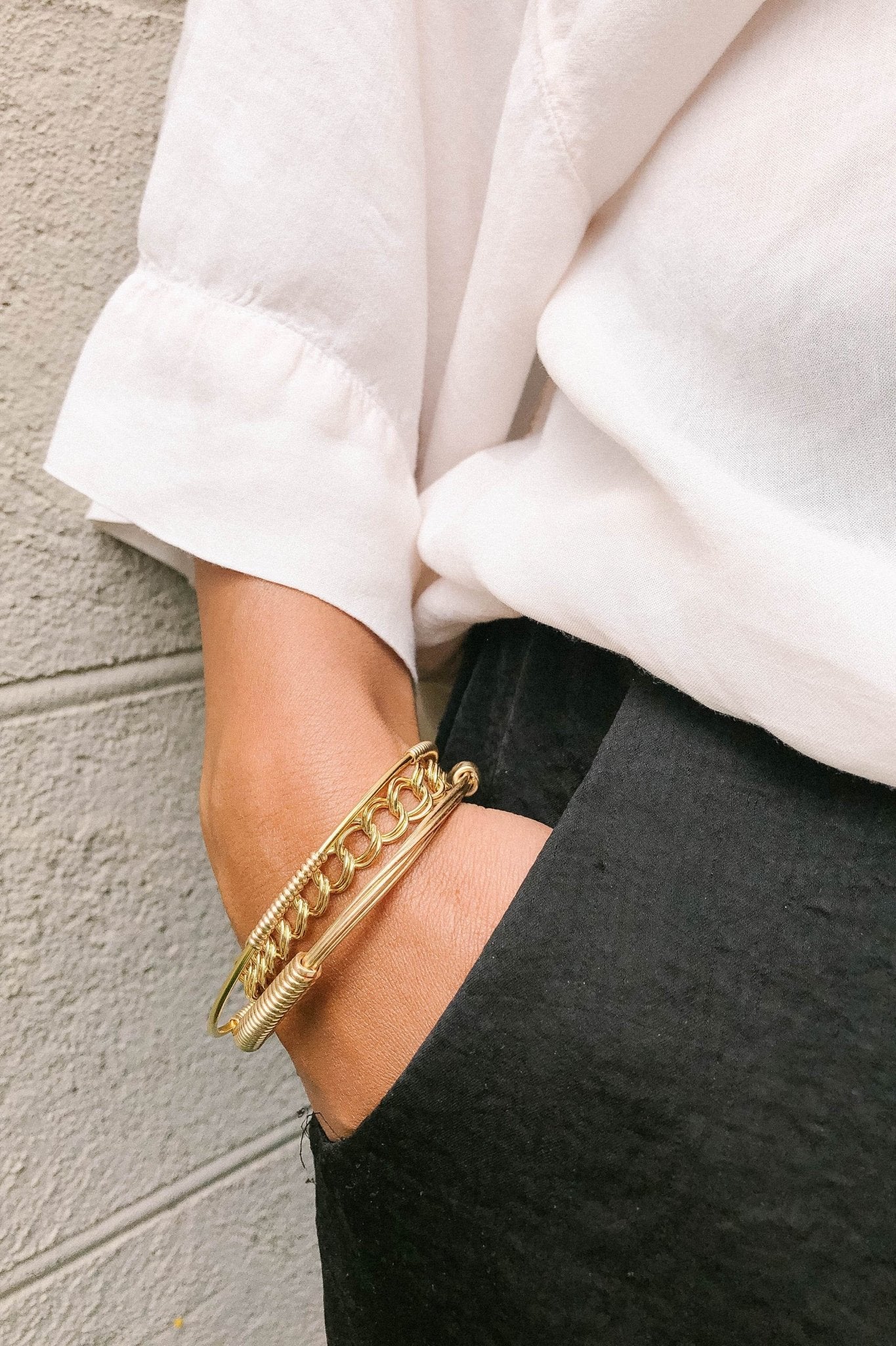 Signature Curb Link Bracelet in gold on a models wrist,