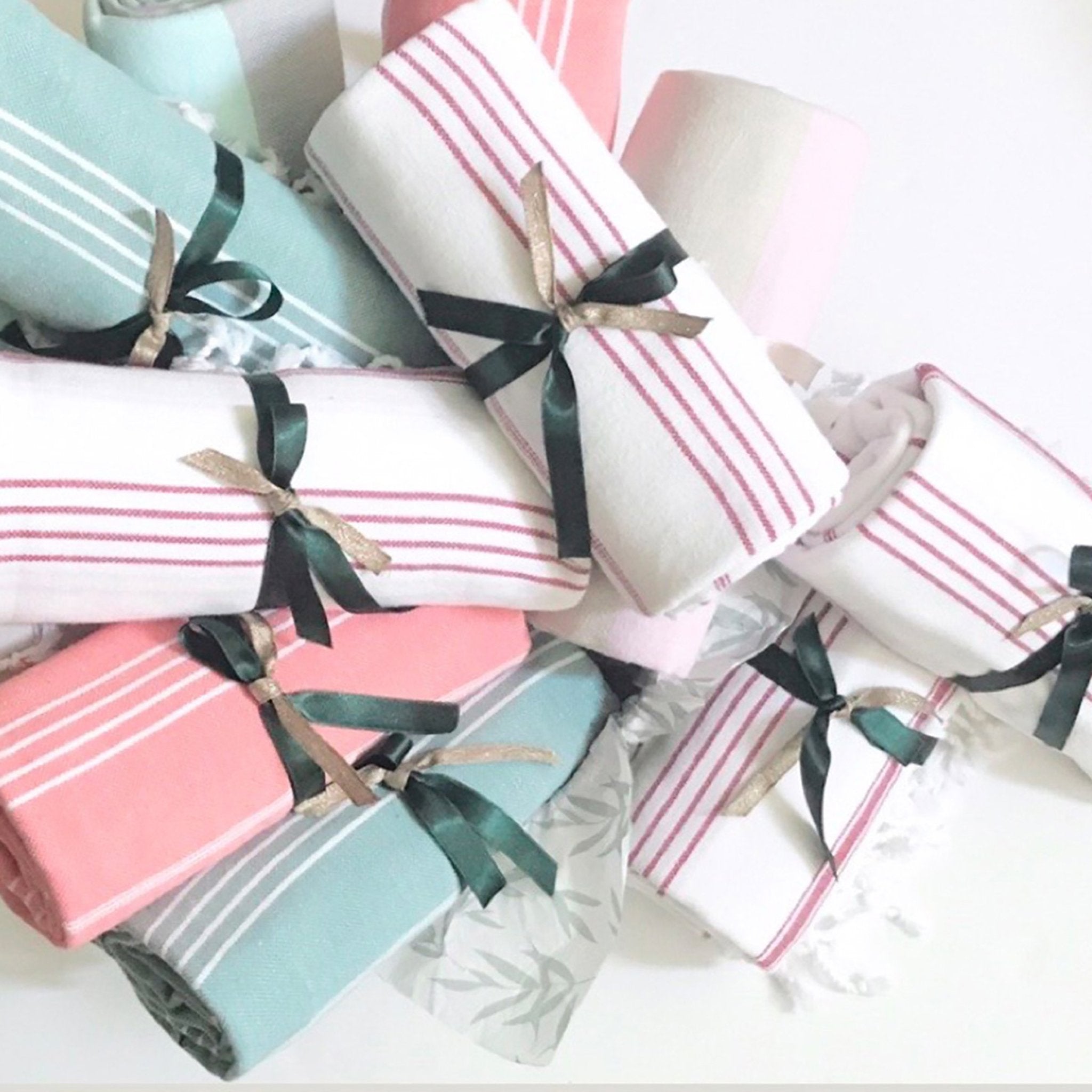 Signature Turkish Cotton Striped Towels multiple colors, each tied with a black and dark gold satin bow.