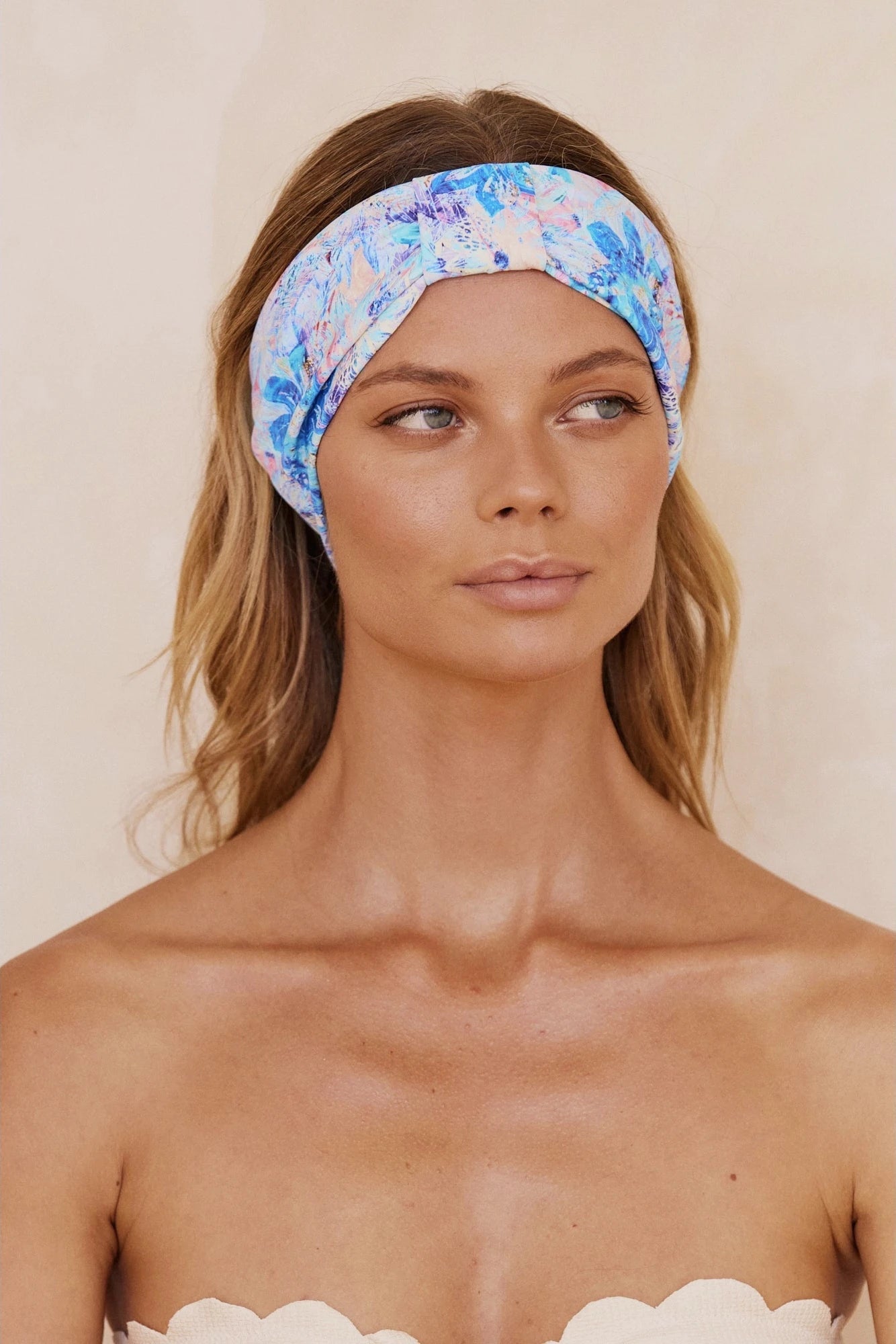 A woman wearing a blue and purple floral-patterned headband.