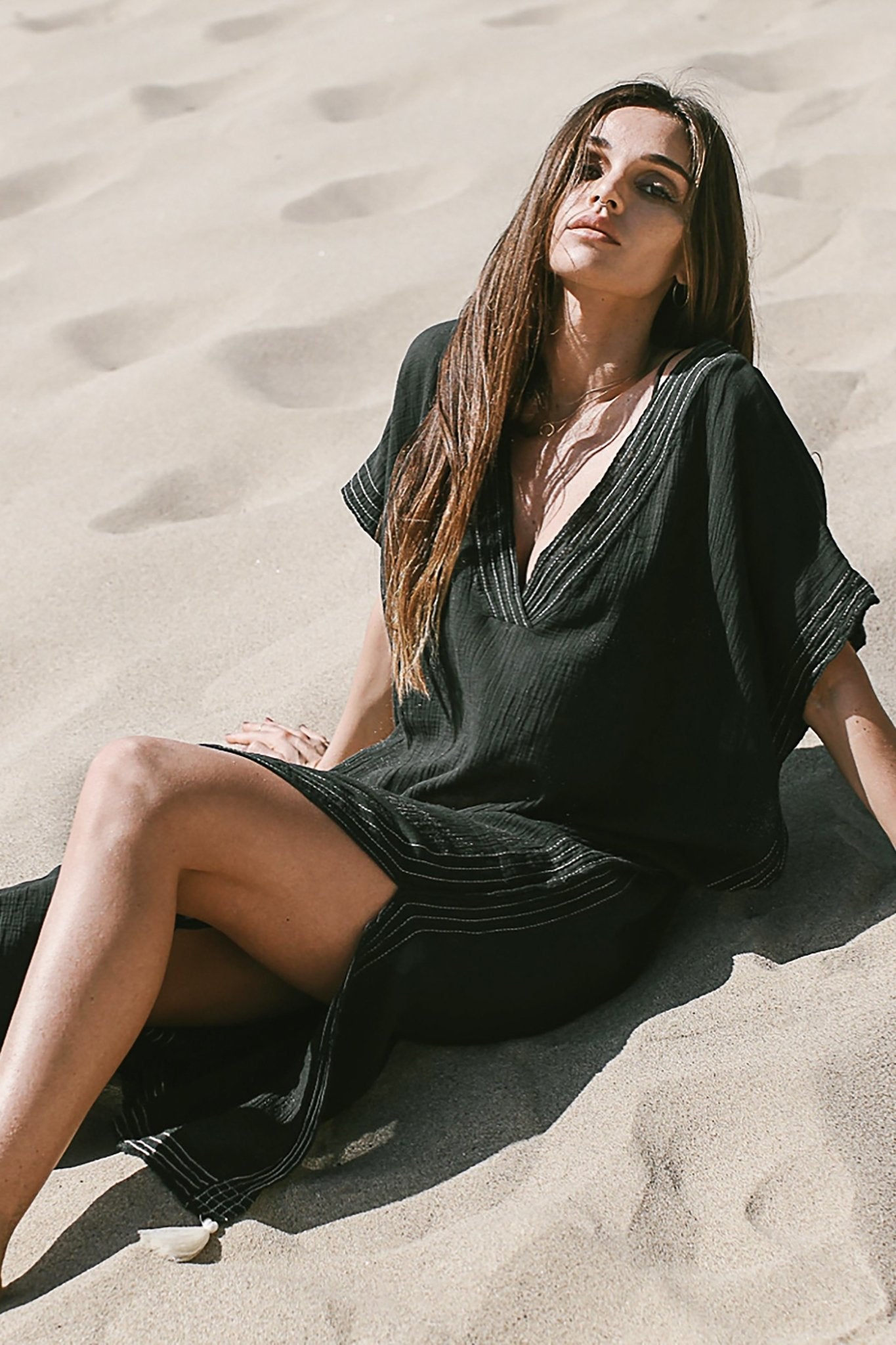 Summer Ready Breezy Kaftan in Black on a woman laying on the beach