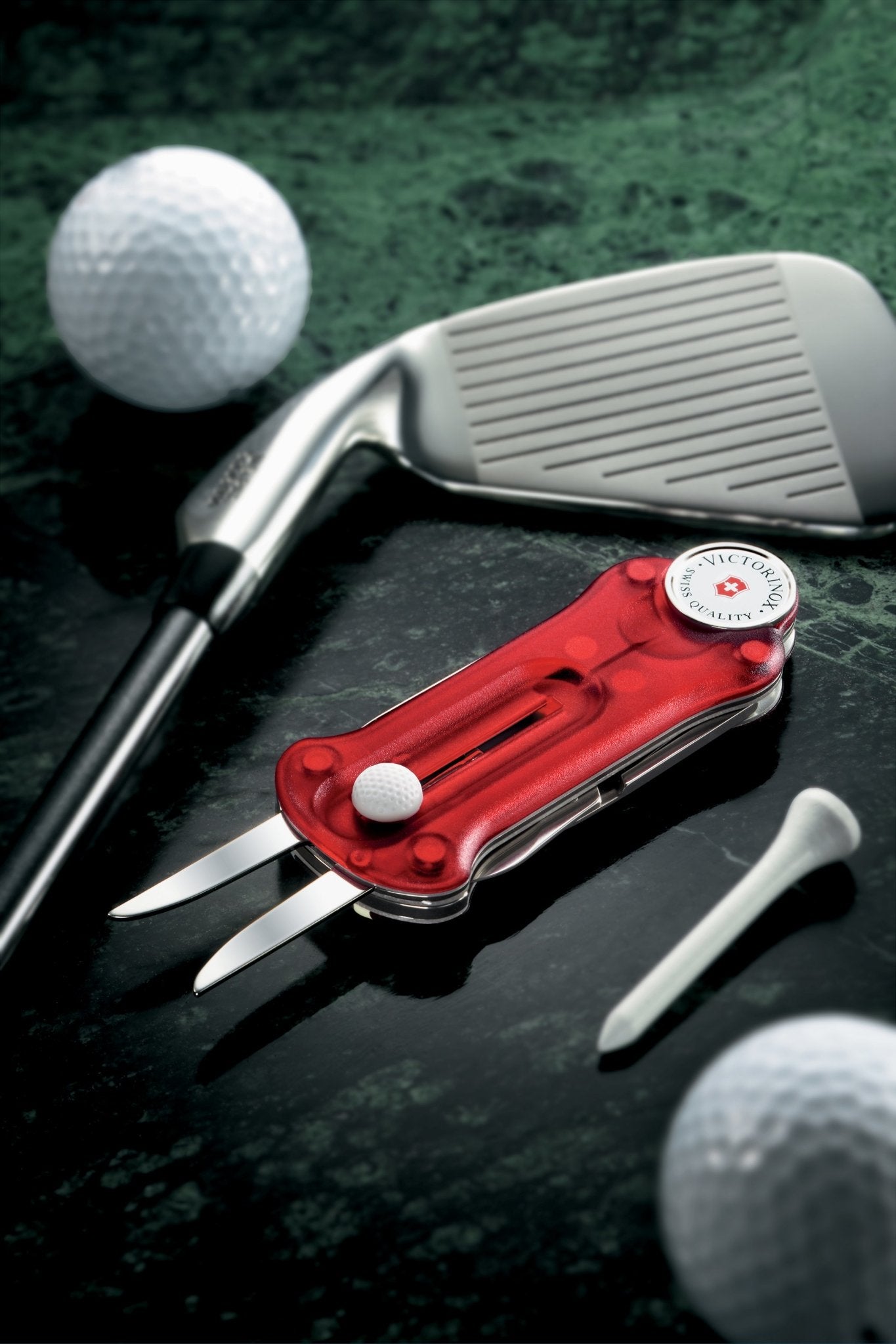 Swiss Golf Tool styled with two golf balls, pitching iron and white tee