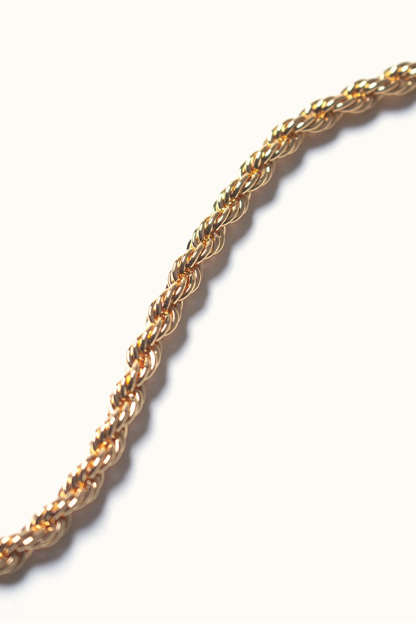 Textured Rope Chain Necklace in textured gold hanging on a white background - L'Atelier Global