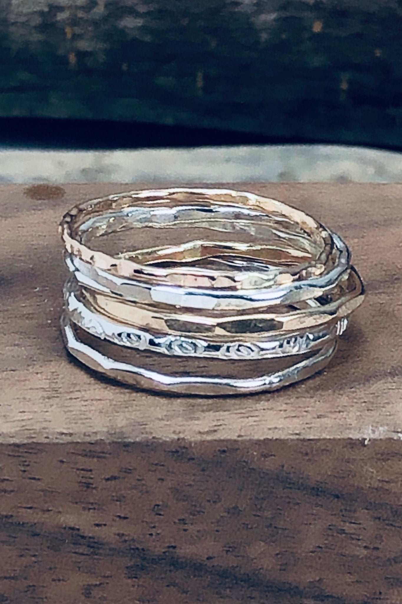 Textured Stacking Rings laying in a piece of textured wood - L'Atelier Global