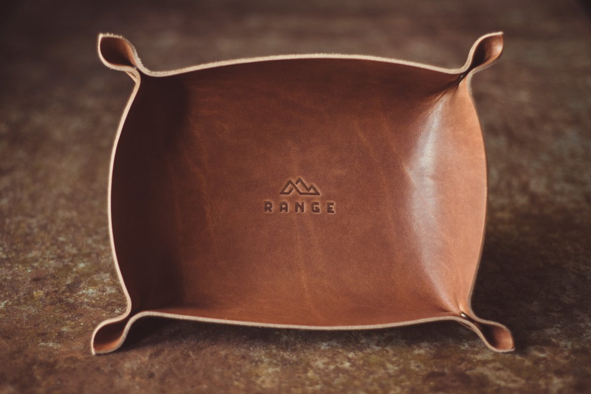 The Horween Leather Catch All Tray in brown on a wooden table