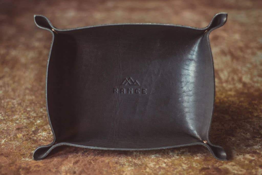 The Horween Leather Catch All Tray in black on a wooden table