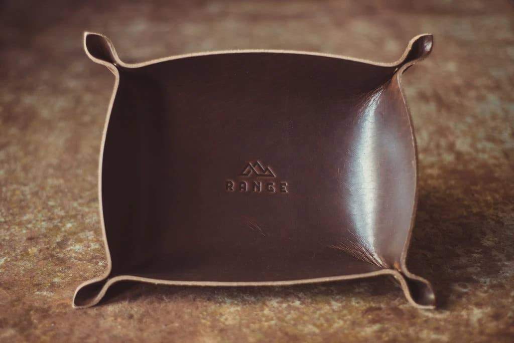 The Horween Leather Catch All Tray in dark brown on a wooden table