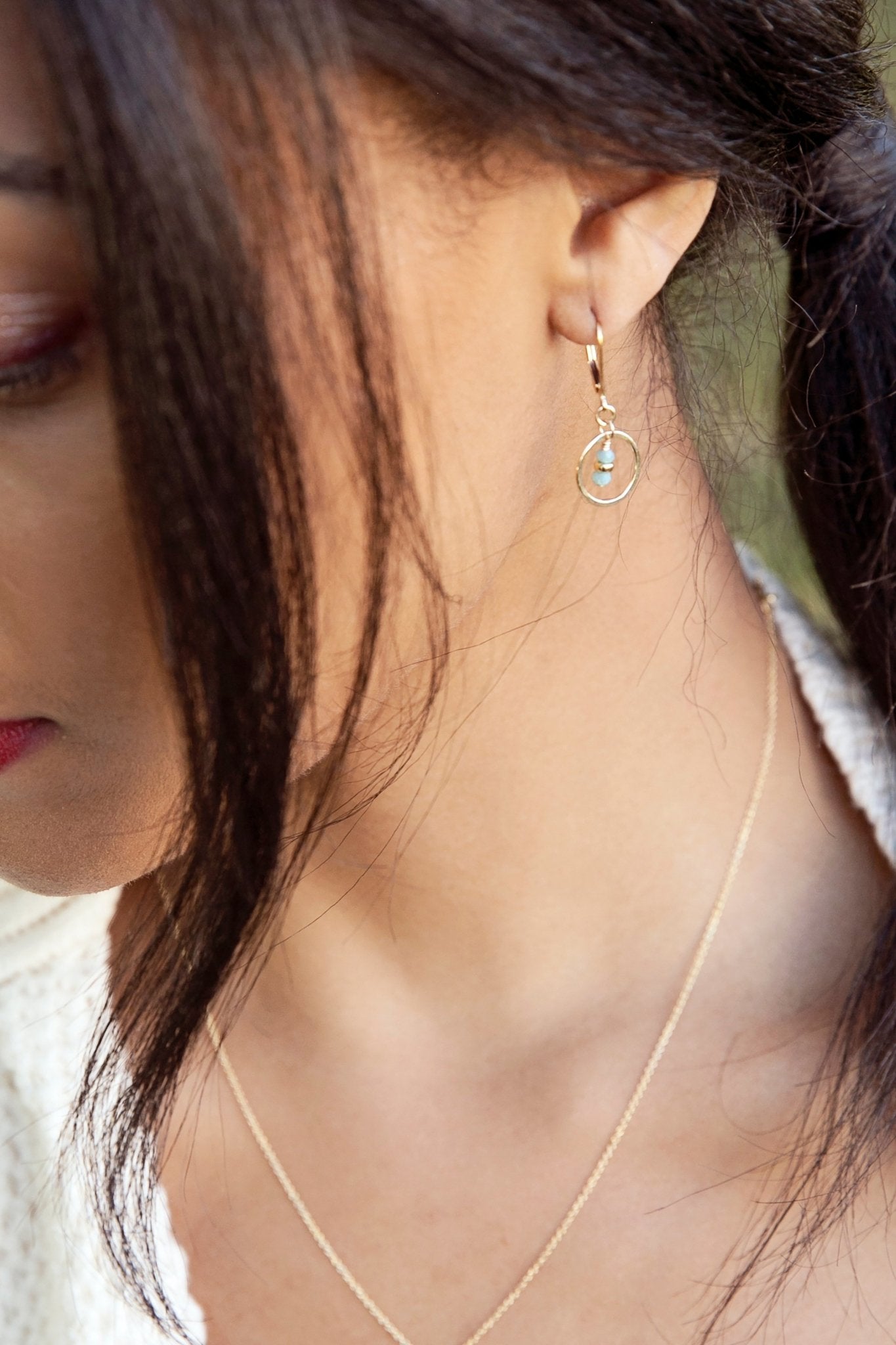 Tiny Gold Circle Earrings with Turquoise Crystals on a female model - L'Atelier Global