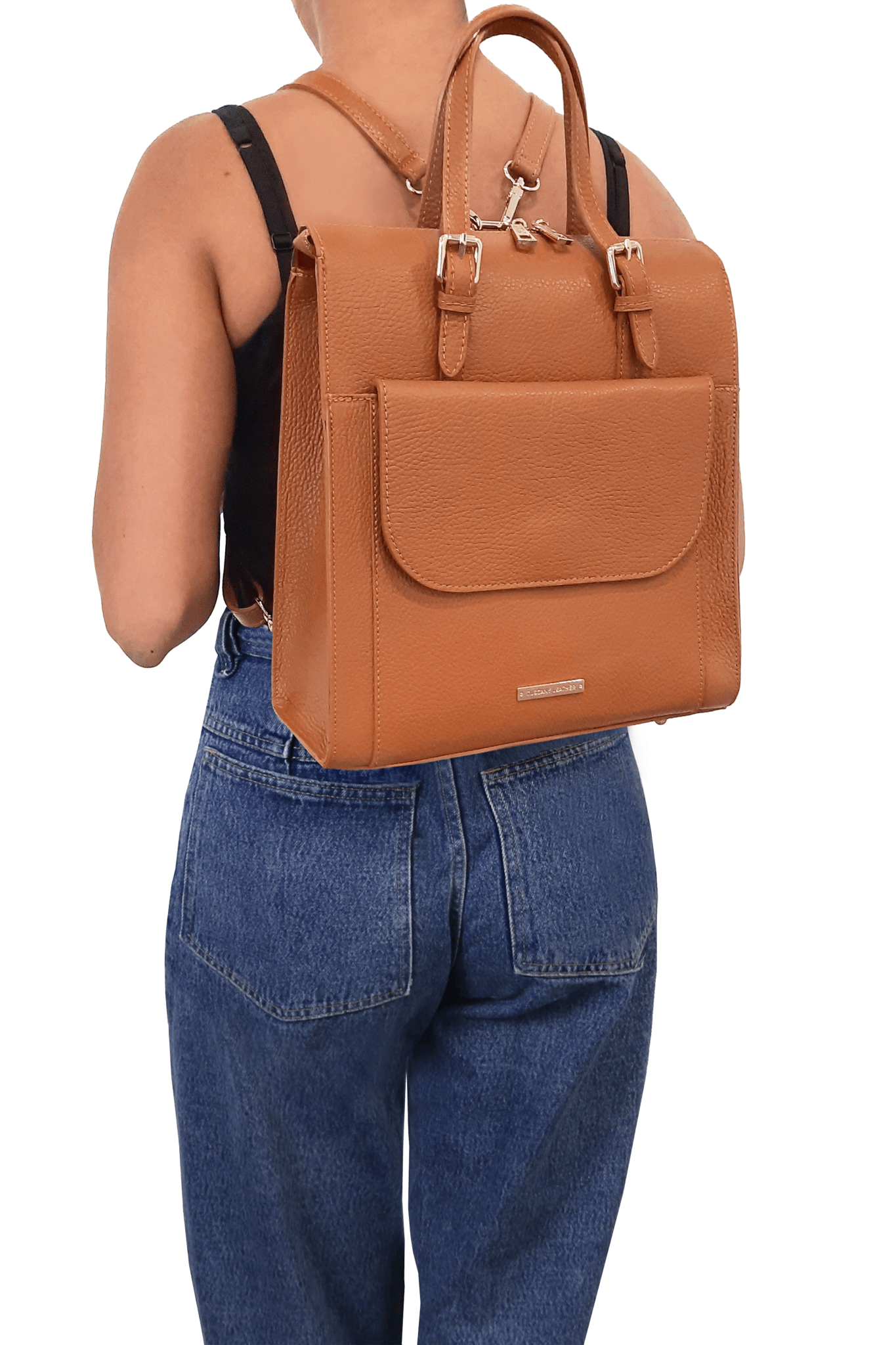Female model is wearing the L Bag Italian Leather Backpack in cognac as a backpack