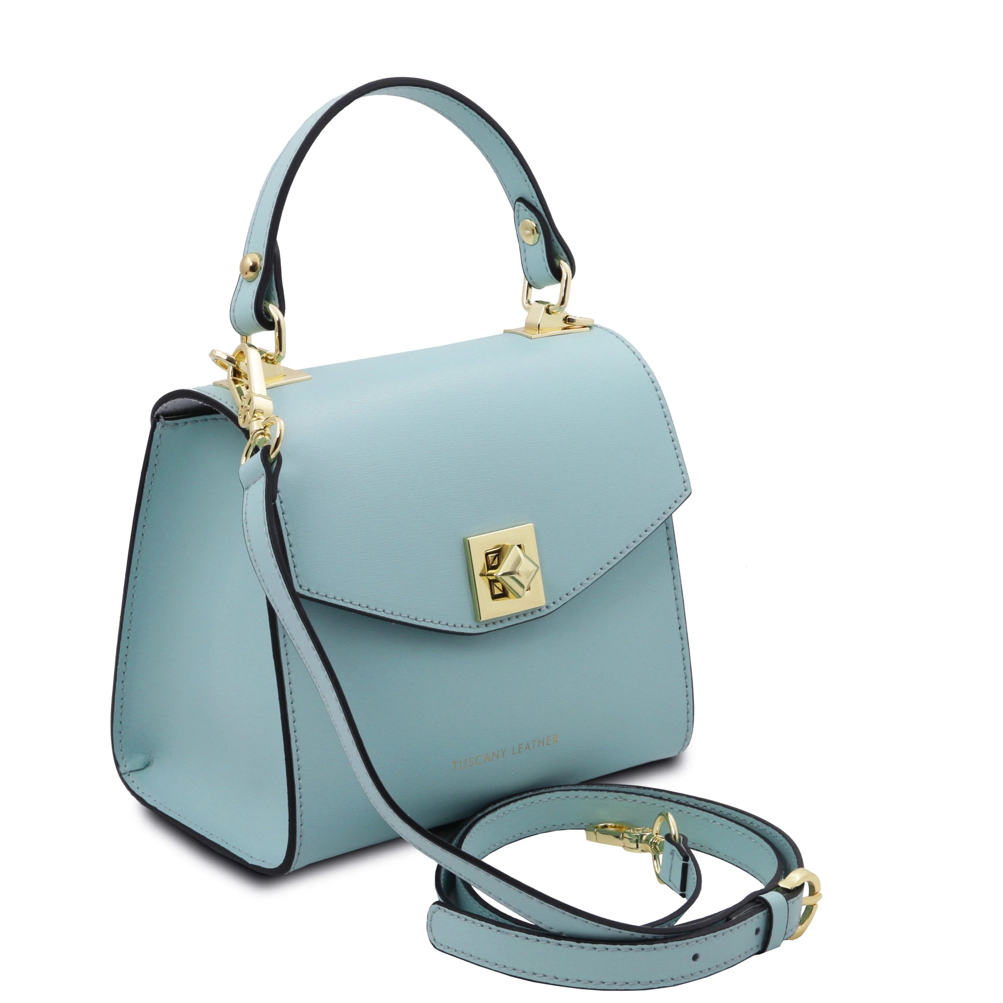 Front angled view TL Bag Italian Leather Mini Bag in light blue showing front fla closure with magnetic closure, top handle and adjustable and detachable shoulder strap