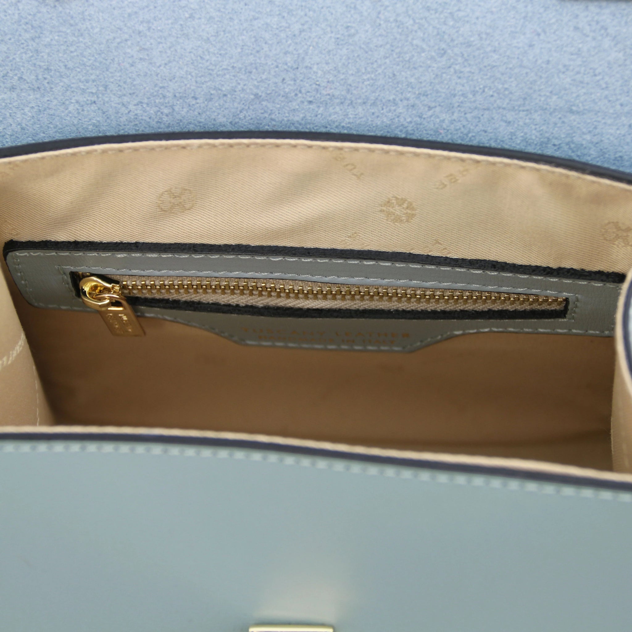 Interior view TL Bag Italian Leather Mini Bag in light blue showing interior zip pocket and beige lining
