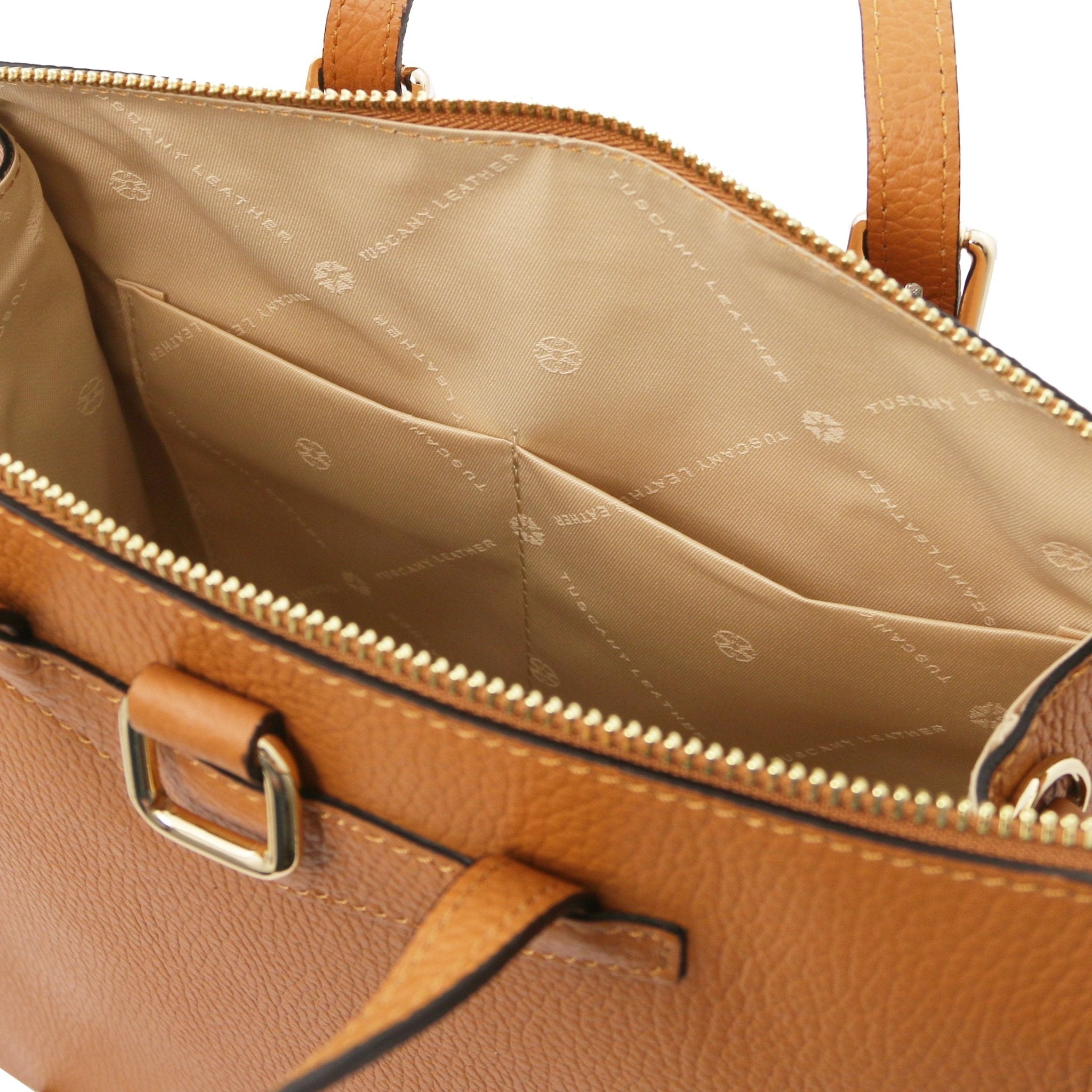 Interior open pockets view TL Bag Leather Backpack in cognac showing beige interior