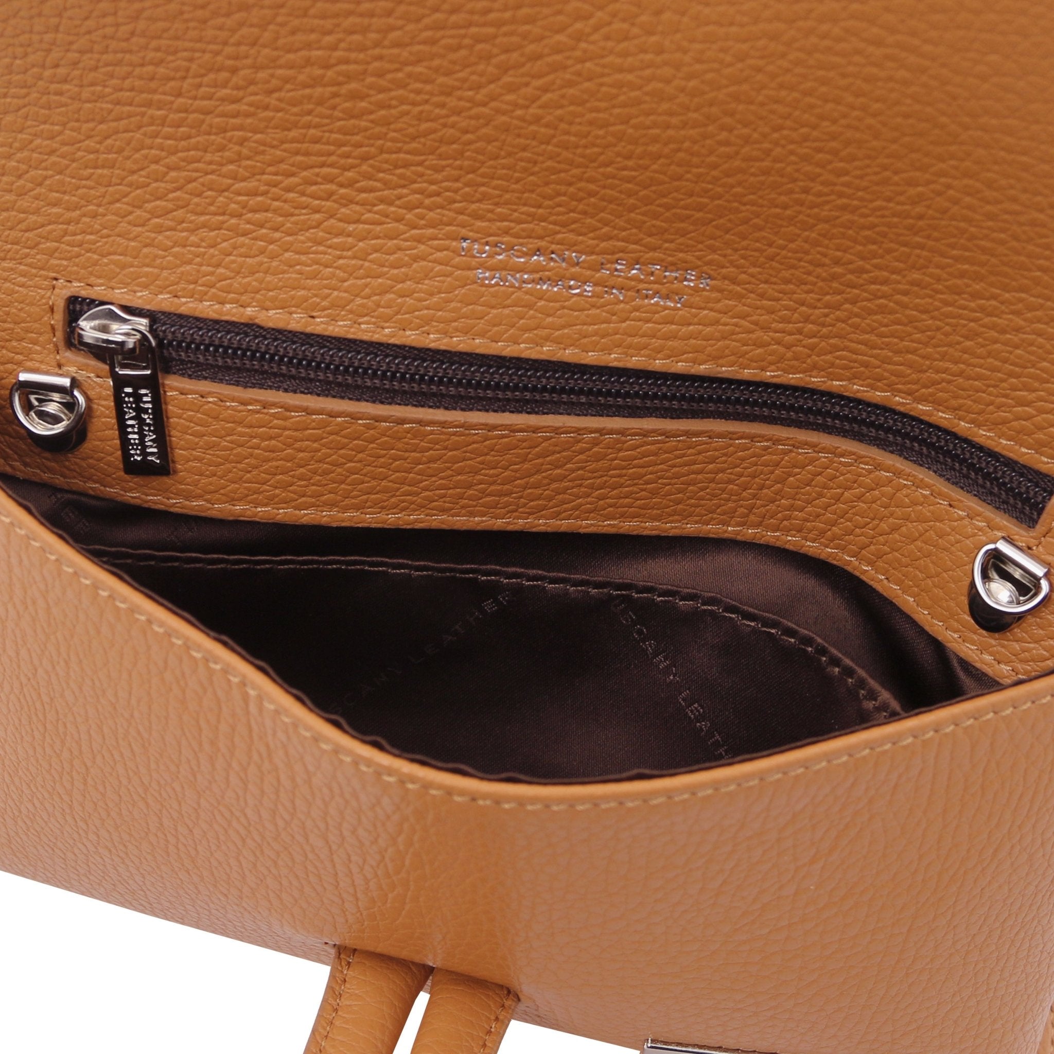 Interior zip pocket view TL Bag Leather Clutch in cognac showing dark brown lining