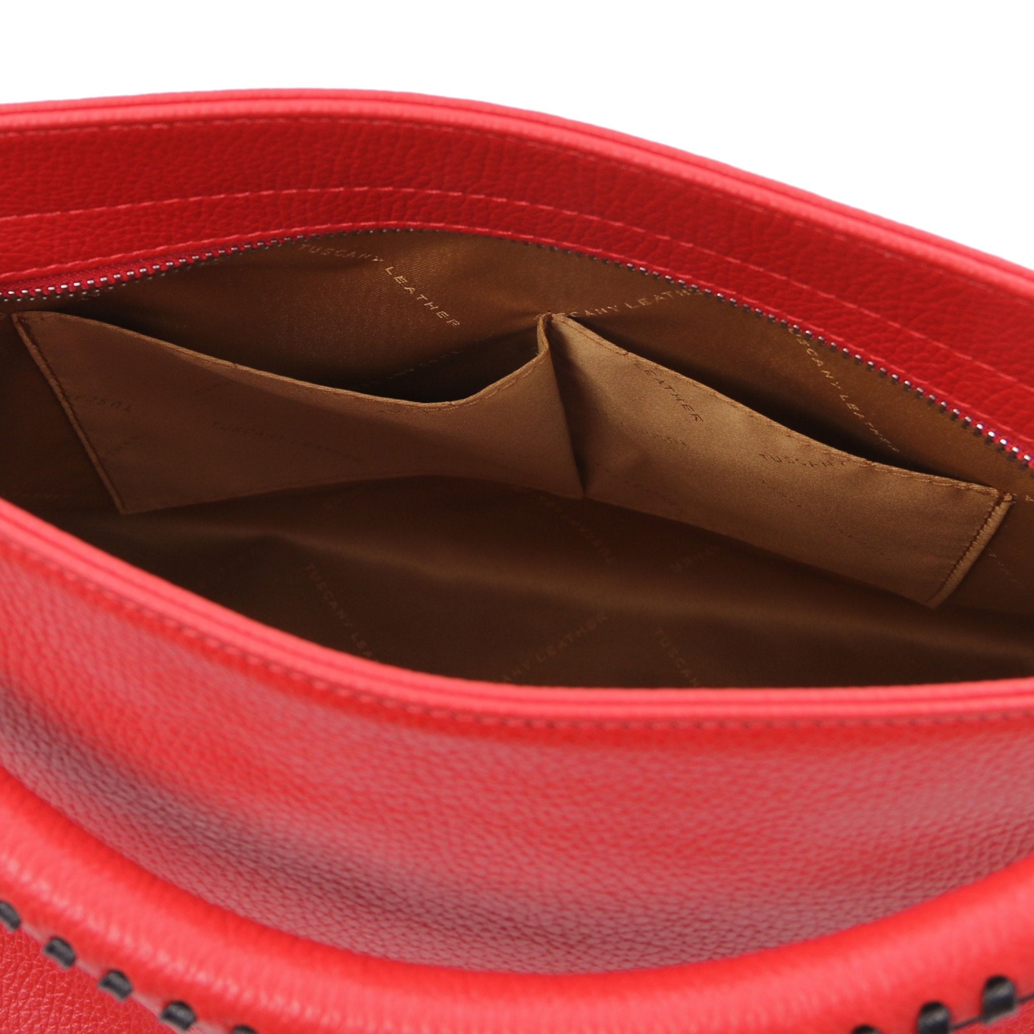 Interior view of the TL Bag Soft Leather Handbag in Red showing two opened pockets and light brown lining on a white background.