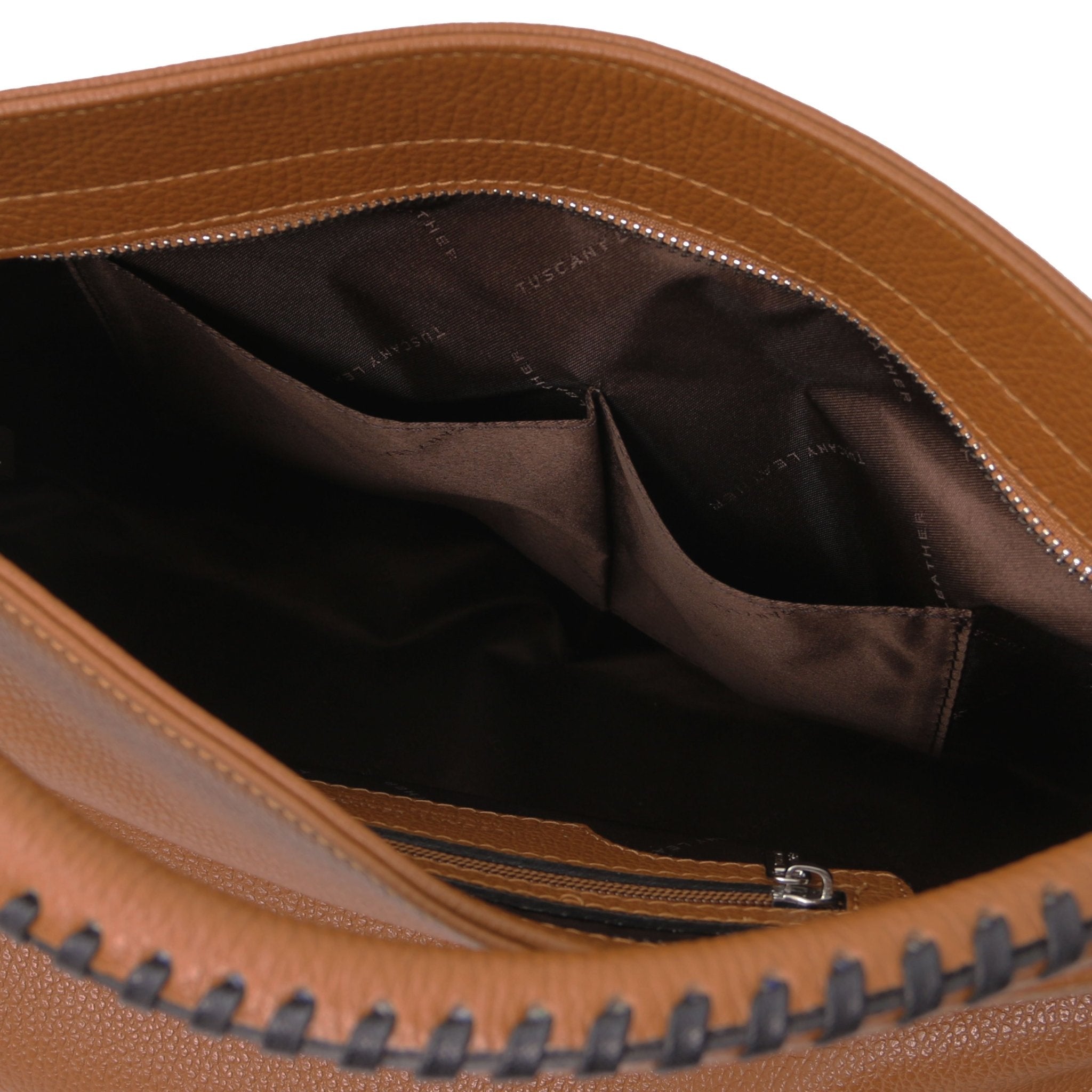 Interior view of the TL Bag Soft Leather Handbag in Cognac showing two opened pockets and dark brown lining on a white background.