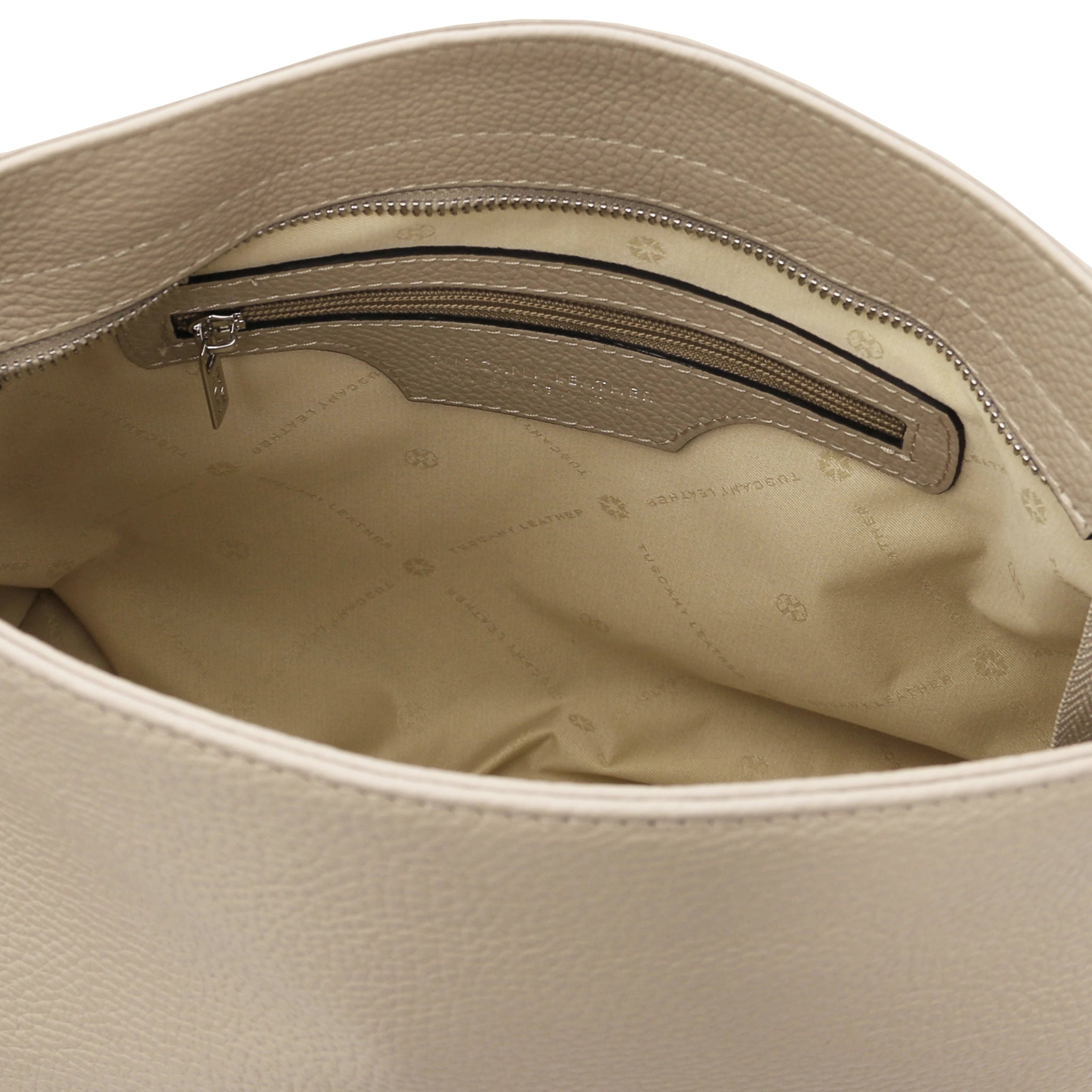 Interior view of the TL Bag Soft Leather Handbag in Beige showing a zippered pockets and light beige lining on a white background.