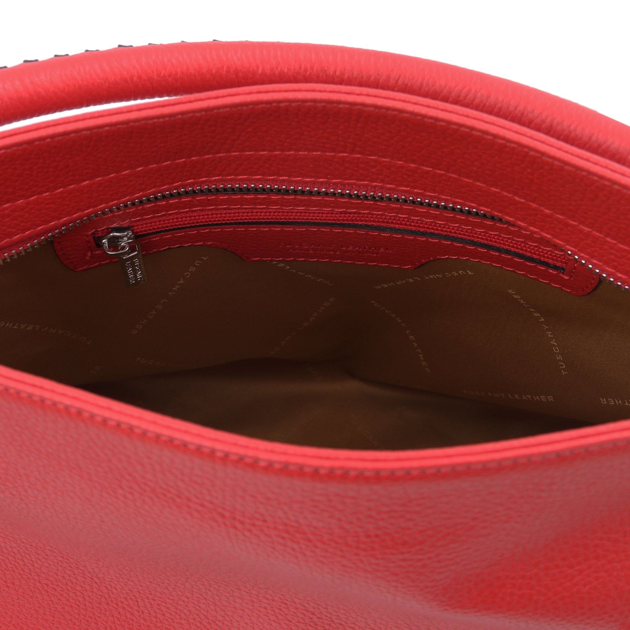 Interior view of the TL Bag Soft Leather Handbag in Red showing a zippered pocket and light brown lining on a white background.