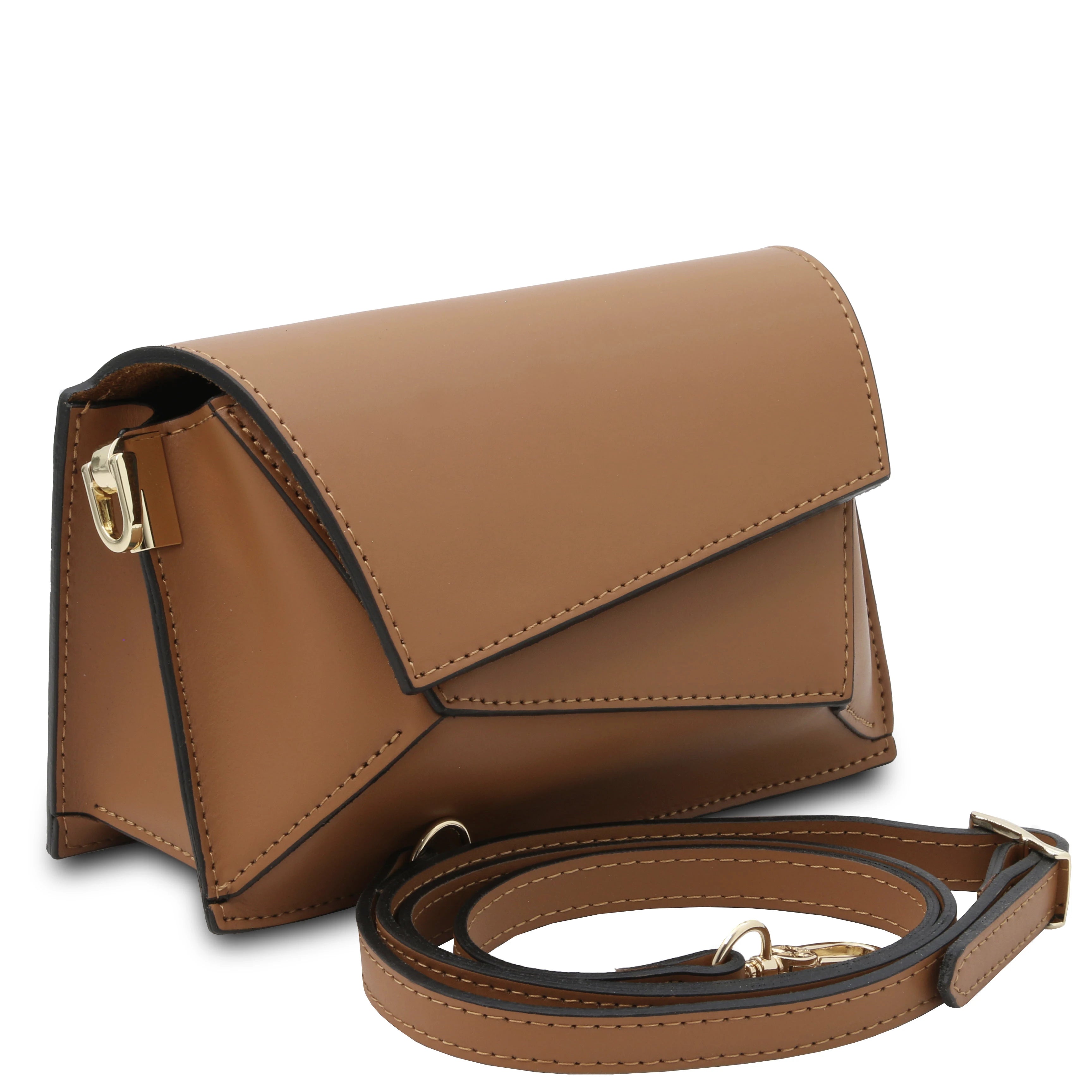 Front angled view TL Leather Assymetrical Shoulder Bag in Cognac showing bag sa a clutch sitting near its deatchable shoulder strap