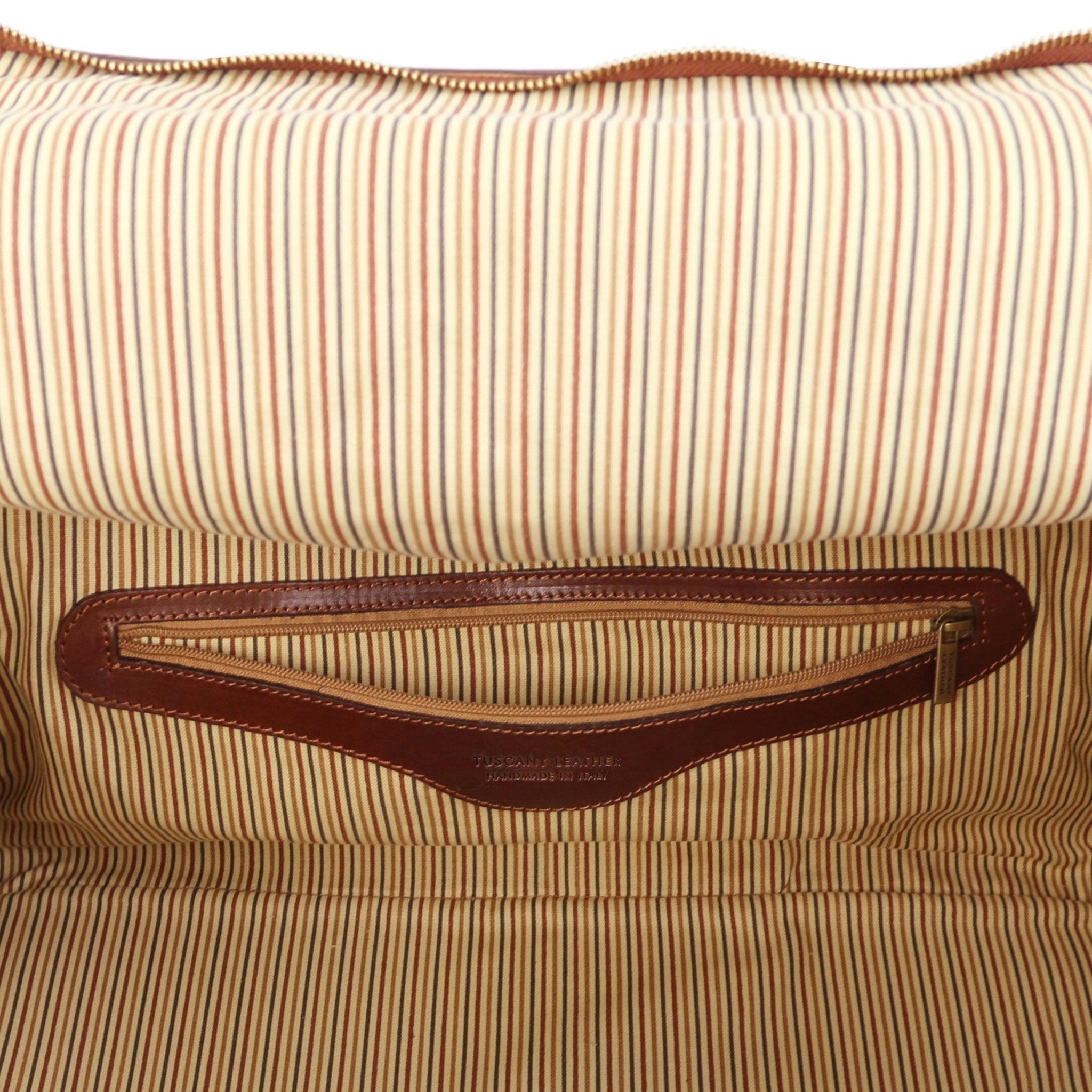 Interior view TL Voyager Travel Leather Bag with Side Pockets in brown showing leather trimme zippered pocket and vintage striped lining