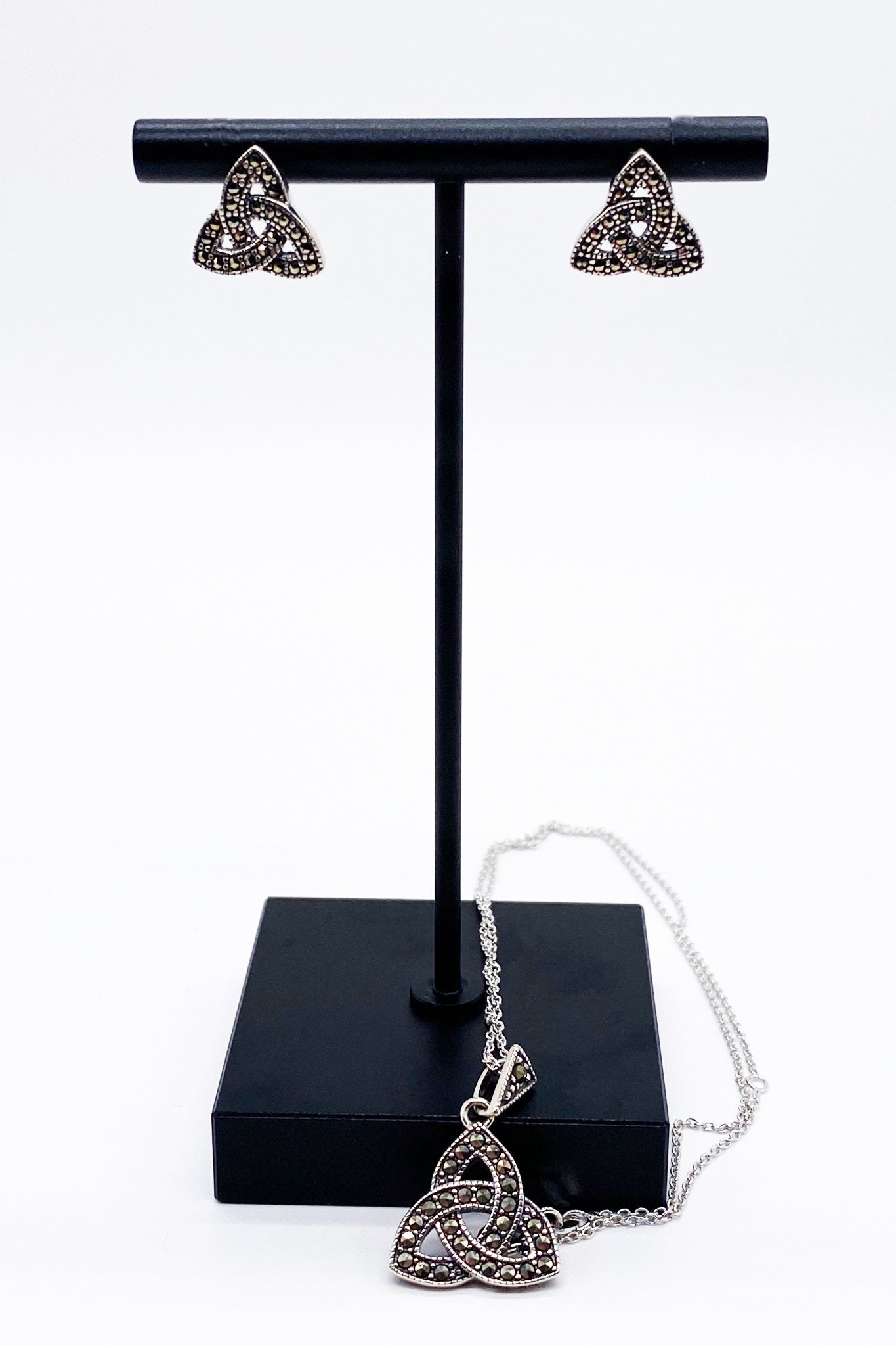 Jewelry Stand showcasing the Trinity Knot Marcasite Stud Earrings and Trinity Knot Pendant Necklace