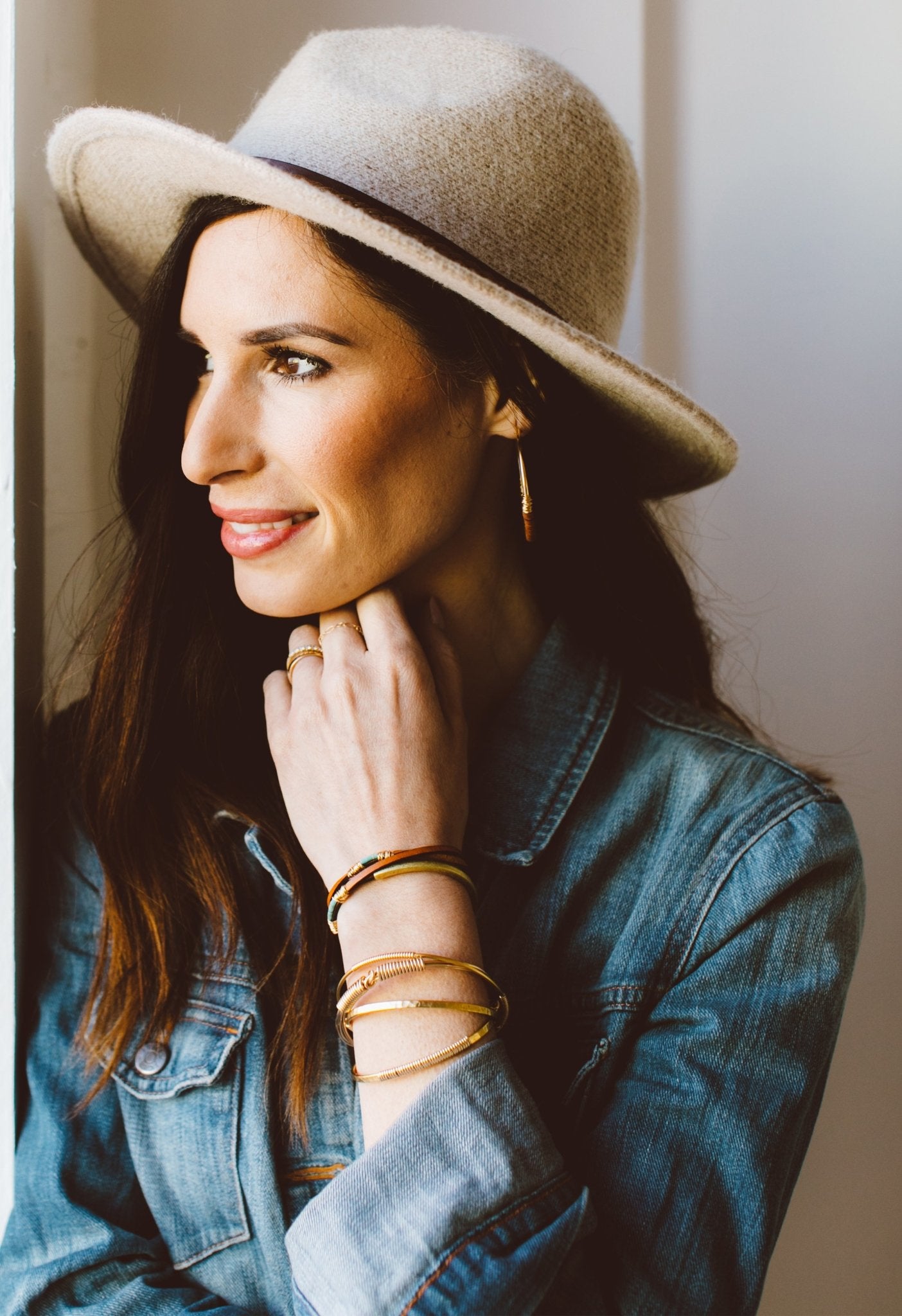 Turquoise Rondelle Saddle Wrap Bracelet on model with her hand resting on her chin