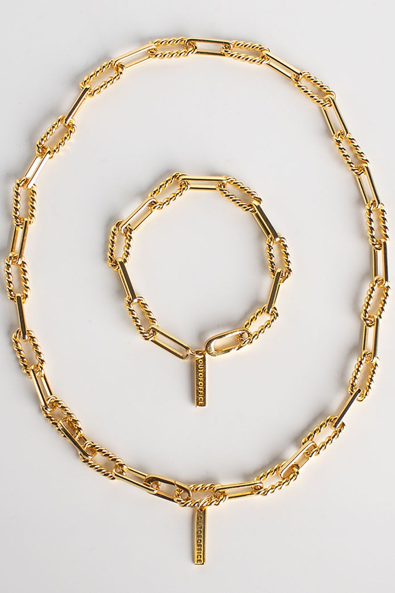 Gold Fill Twisted Paperclip Chain Necklace and bracelet on a white background