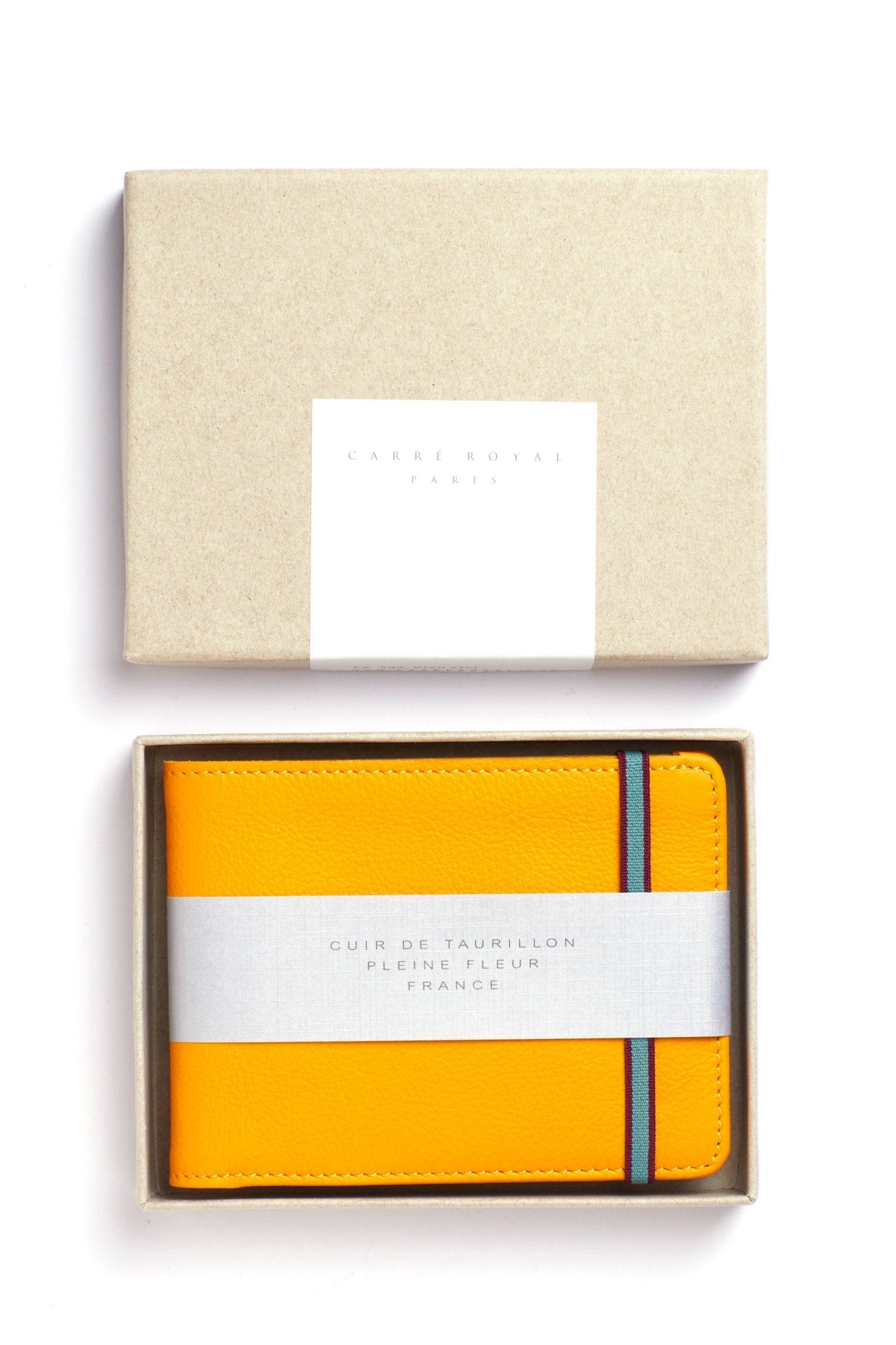 Yellow Wallet with a light blue and burgundy elastic closure and its box on a white background - L'Atelier Global