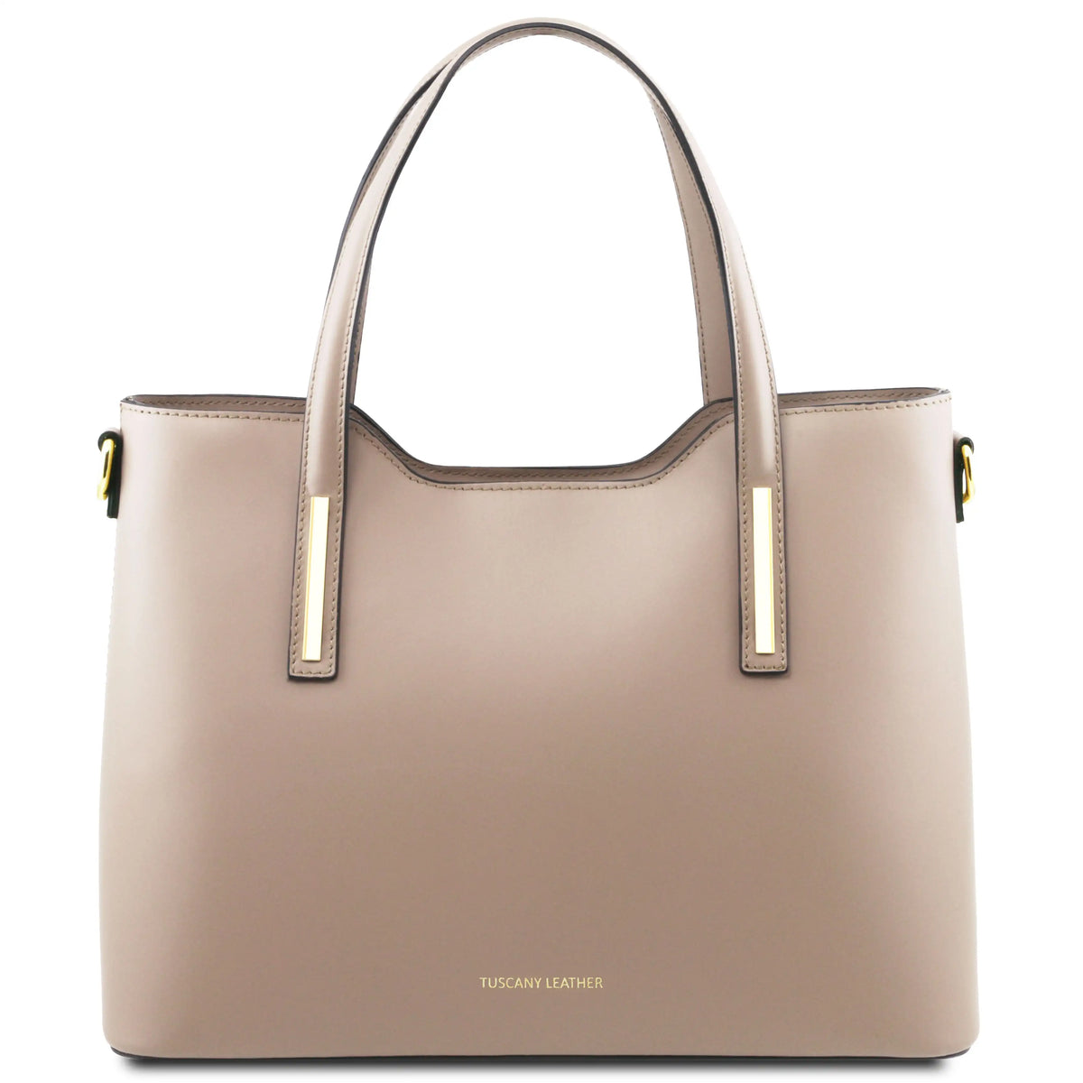A structured tote bag in light taupe leather with gold-tone hardware and a small gold 'TUSCANY LEATHER' logo on the front, set against a plain white background.
