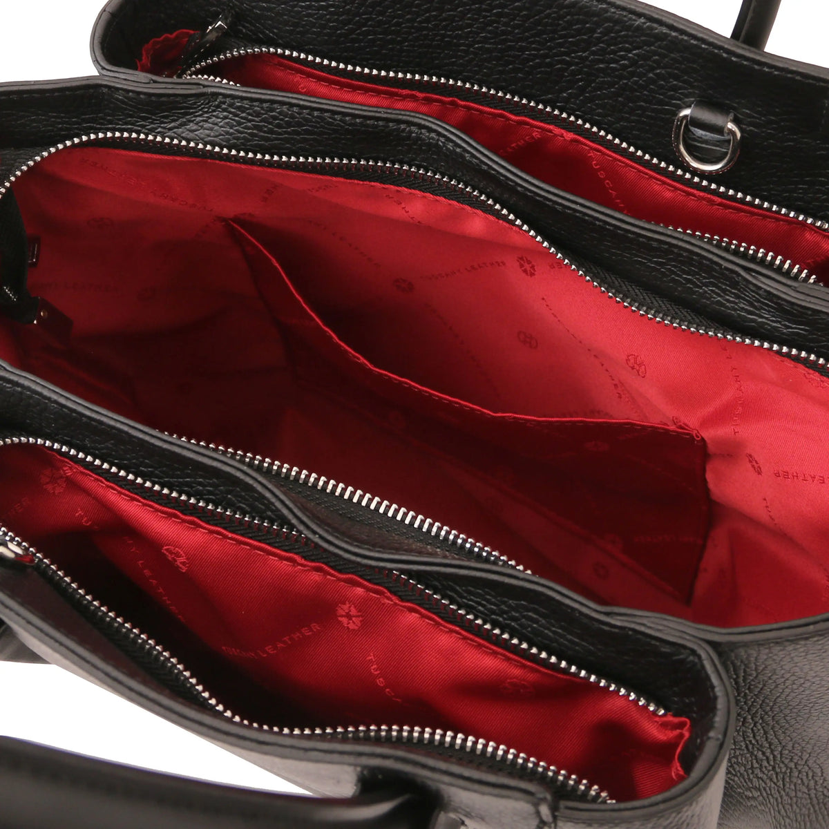 Cognac leather handbag with a red interior lining, open pocket, 3 compartments and visible brand logo.