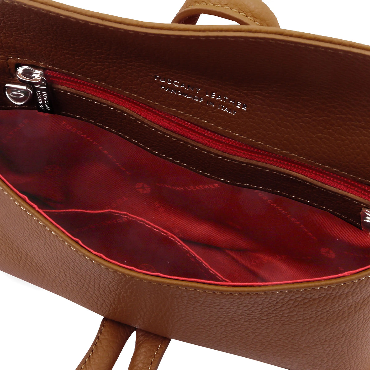 Interior zip pocket view TL Bag Leather Clutch in cognac showing red lining