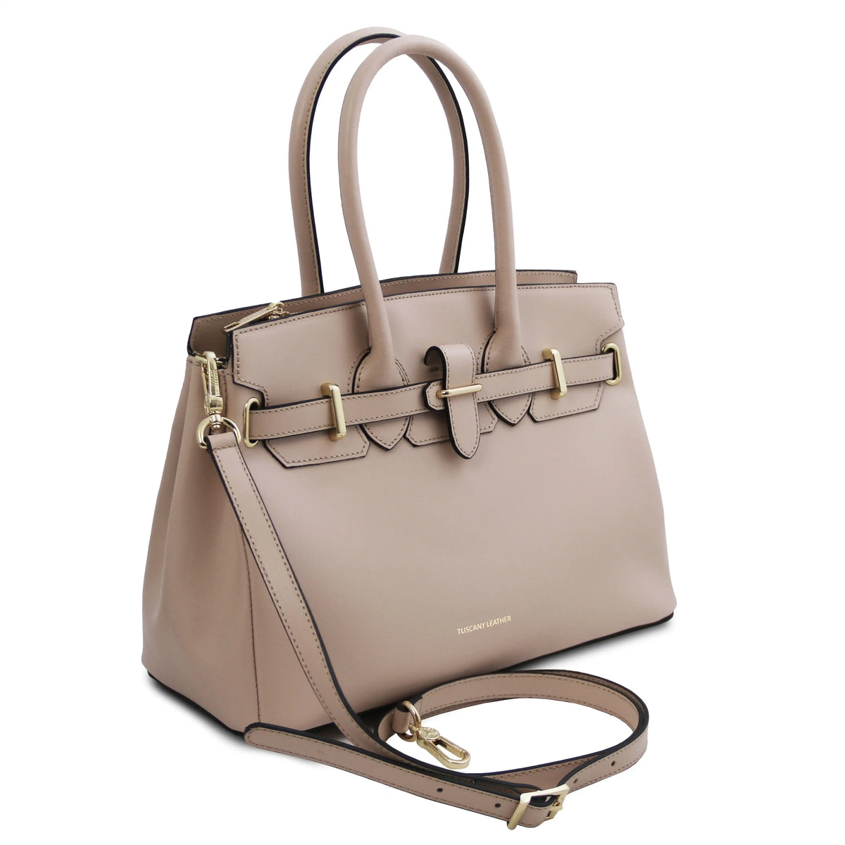 A structured light beige leather handbag with gold-tone hardware, dual top handles, a front strap detail, and a detachable shoulder strap, photographed on a clean white background.