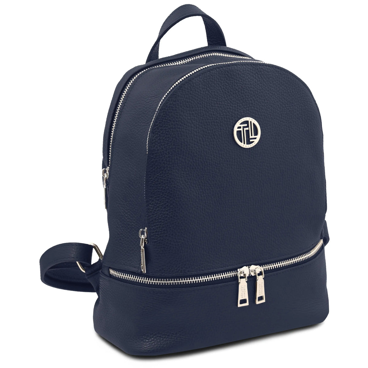 A dark blue pebbled leather backpack with silver-tone hardware, featuring a top handle, a lower zippered compartment, and a circular metallic logo emblem on the front.