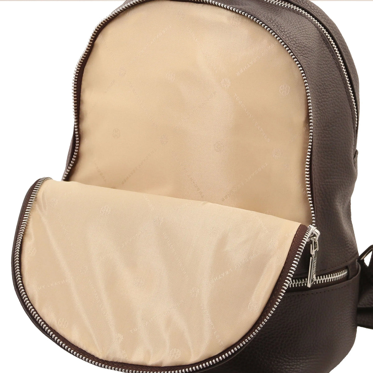 Close-up of a dark brown pebbled leather backpack with the front zippered compartment open, showing a beige quilted interior lining.