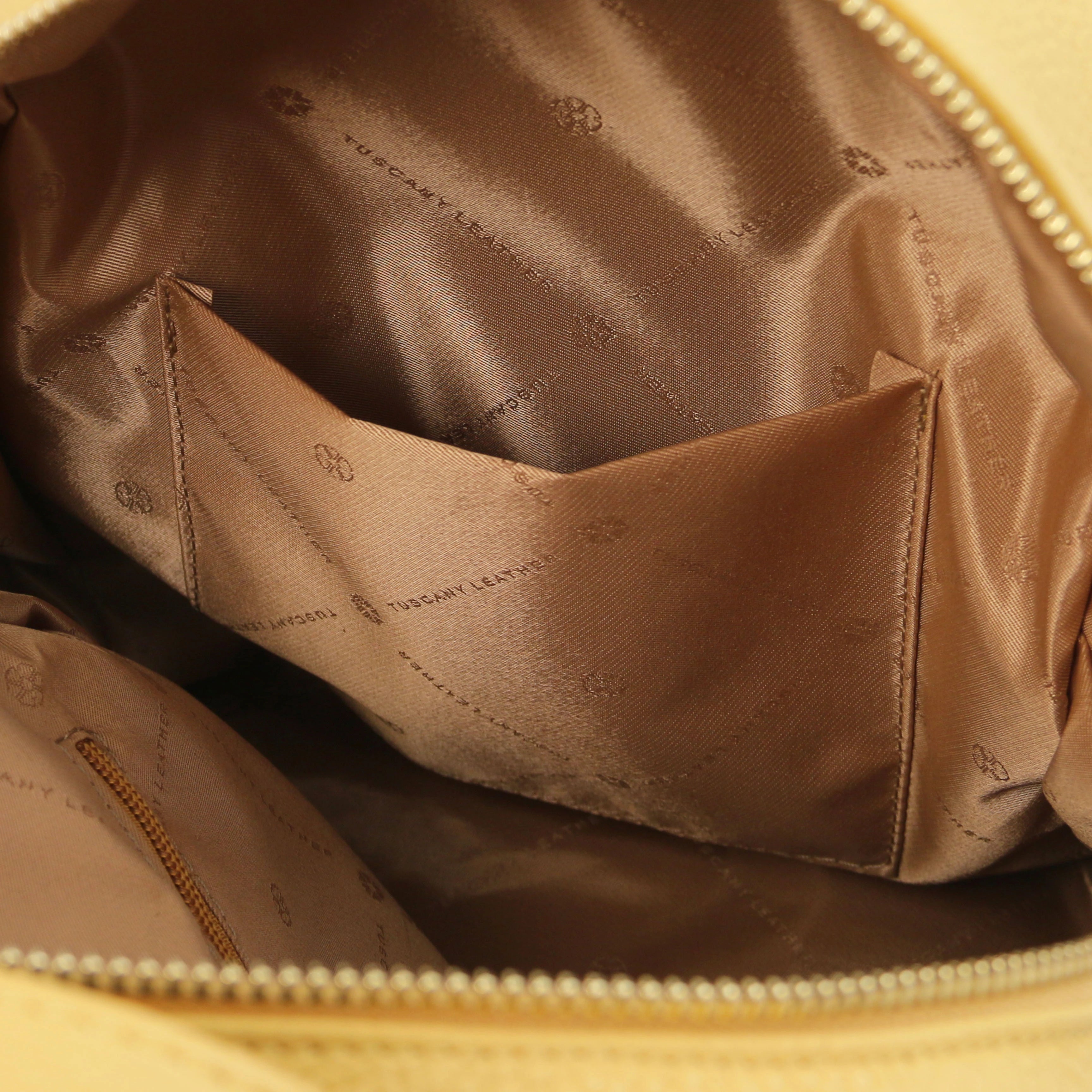 Interior open pocket view TL Bag Italian Soft Leather Zip Backpack in pale yellow showing tan lining