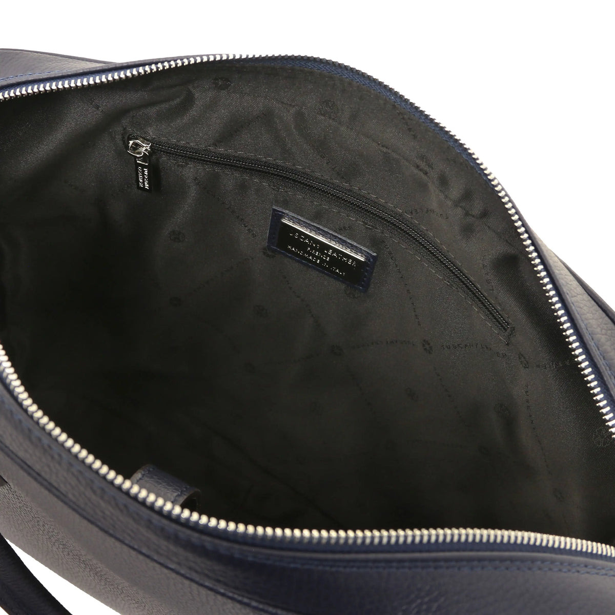 Close-up of a blue leather bag with a zipper, showing the black interior and zip pocket